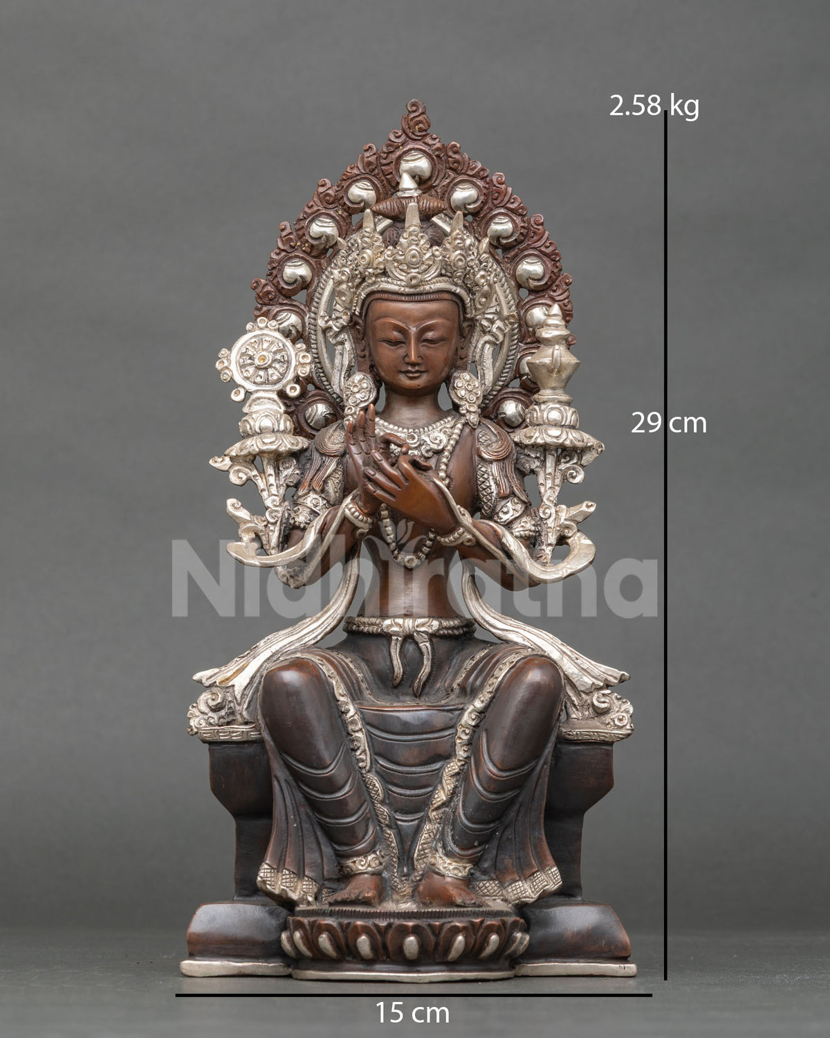 Front view of oxidized copper Maitreya Buddha statue from Nepal seated on throne with silver accents