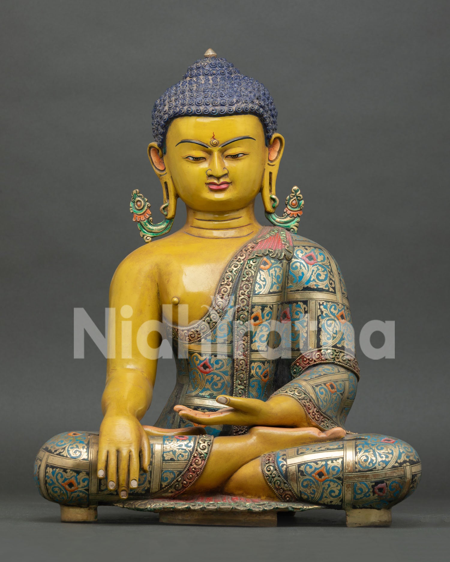Front view of Shakyamuni Buddha statue, handcrafted in copper with vibrant hand painted details from Nepal