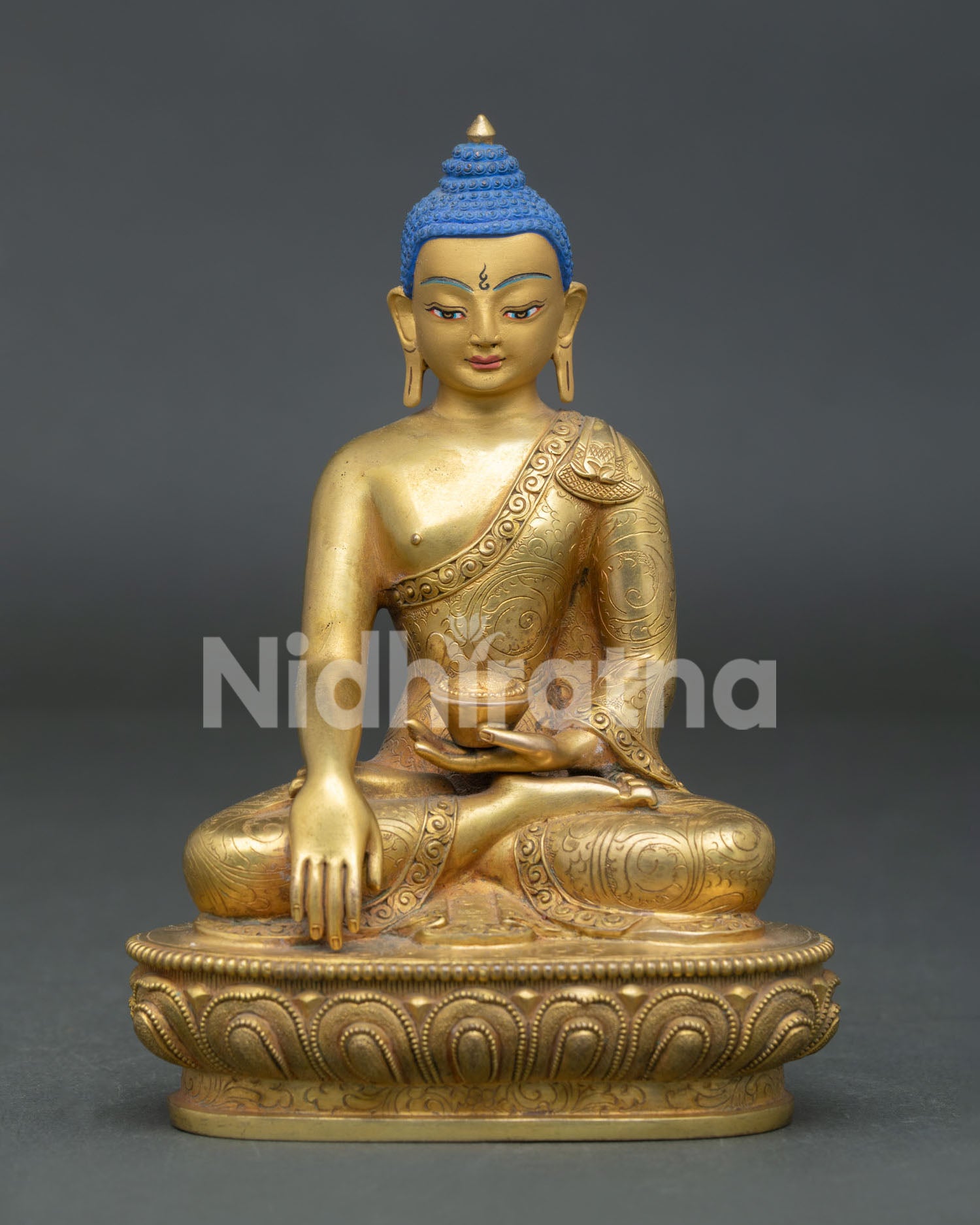 Front view of Shakyamuni Buddha statue handcrafted in Nepal with gold finish, lotus pedestal, and serene expression