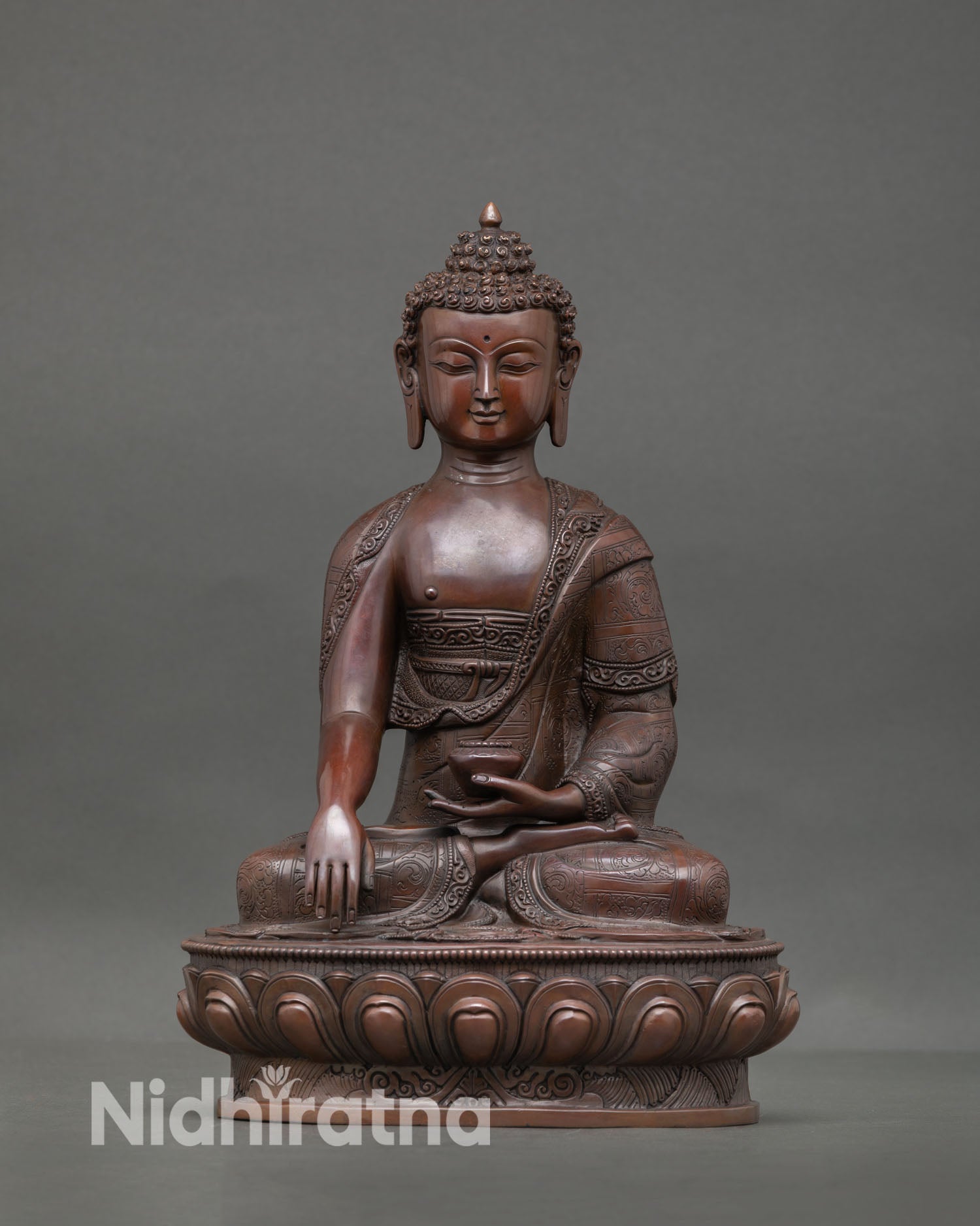 Front view of Shakyamuni Buddha statue with oxidized copper finish, Bhumisparsha Mudra symbolizing enlightenment and spiritual awakening