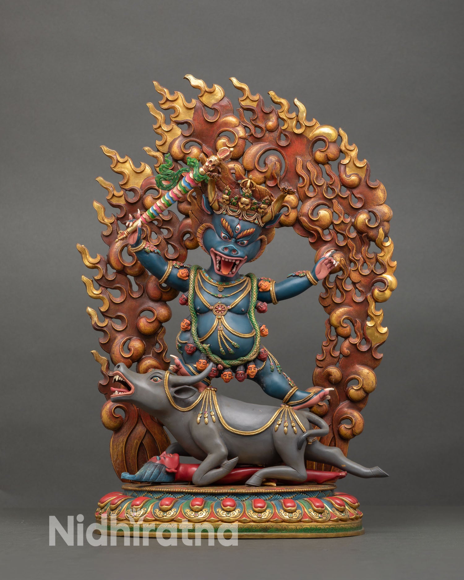 Front view of Tibetan Yamantaka statue handcrafted in Nepal with copper body, gold gilded details, wrathful expression, and dynamic buffalo pedestal scene