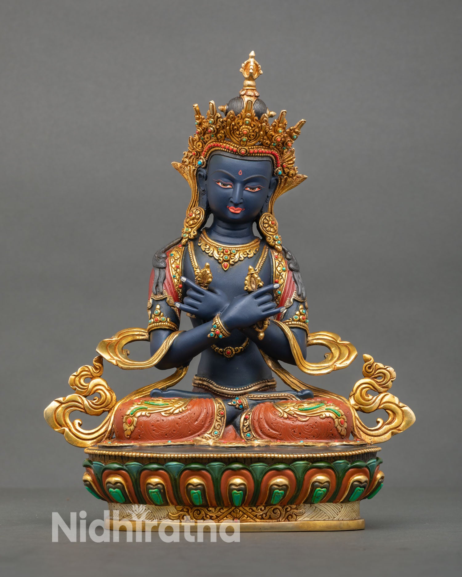 Front view of Vajradhara Buddha statue handcrafted in Nepal with gold gilded copper, vajra and bell, and serene expression seated on lotus pedestal