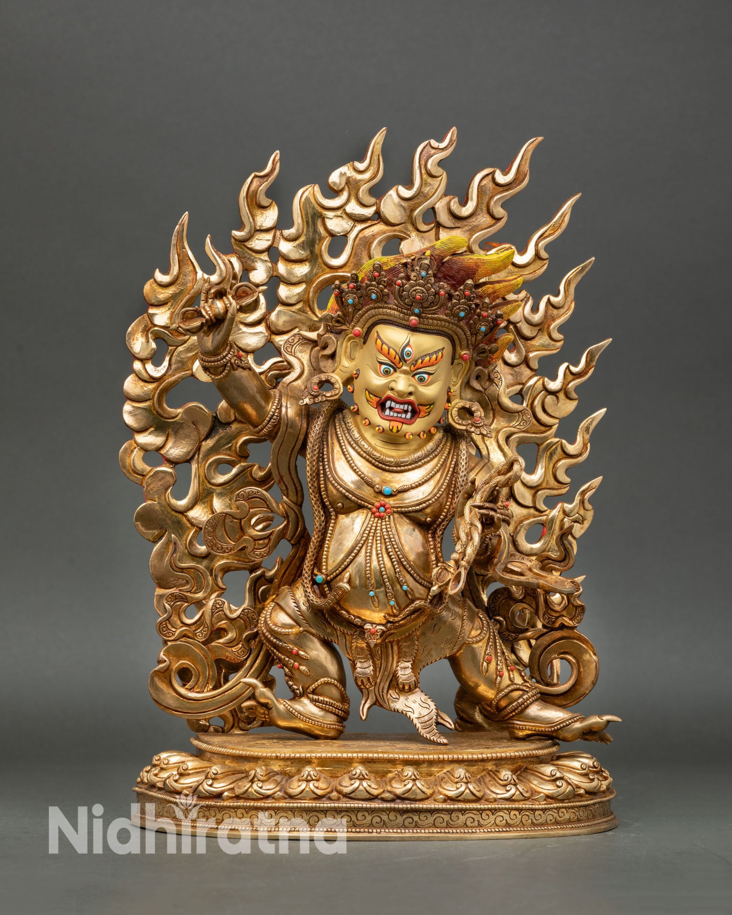 Front view of Vajrapani statue fierce protector deity copper sculpture from Nepal 24K gold fire gilding wrathful expression Tibetan Buddhist art