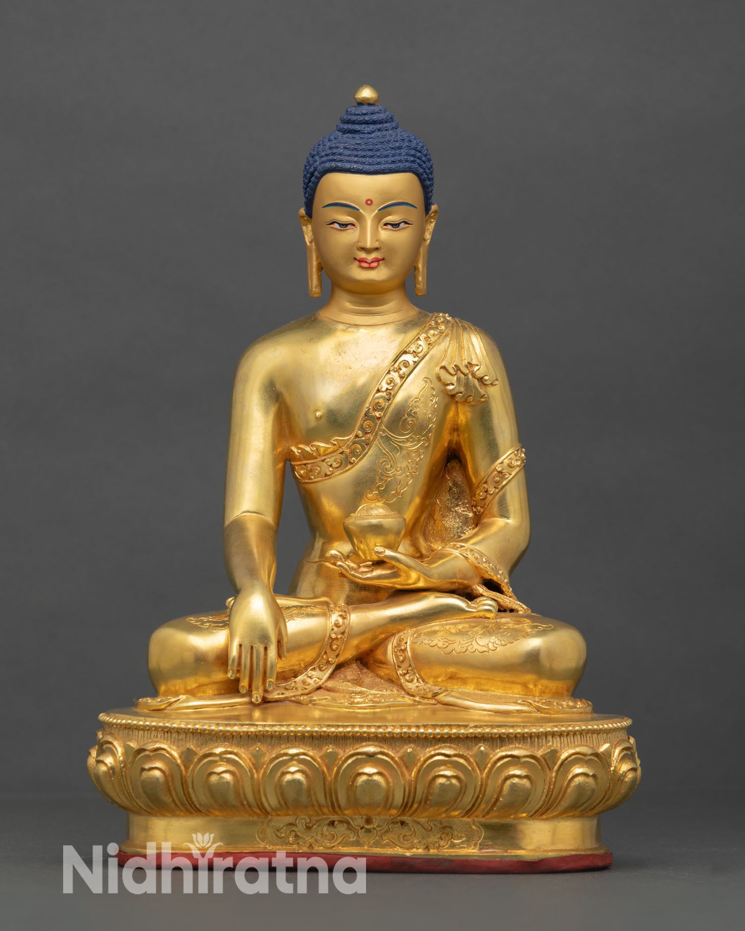 Front view of Shakyamuni Buddha statue, copper, gold gilded finish, gold painted face, seated lotus pedestal, Nepal artisan sculpture