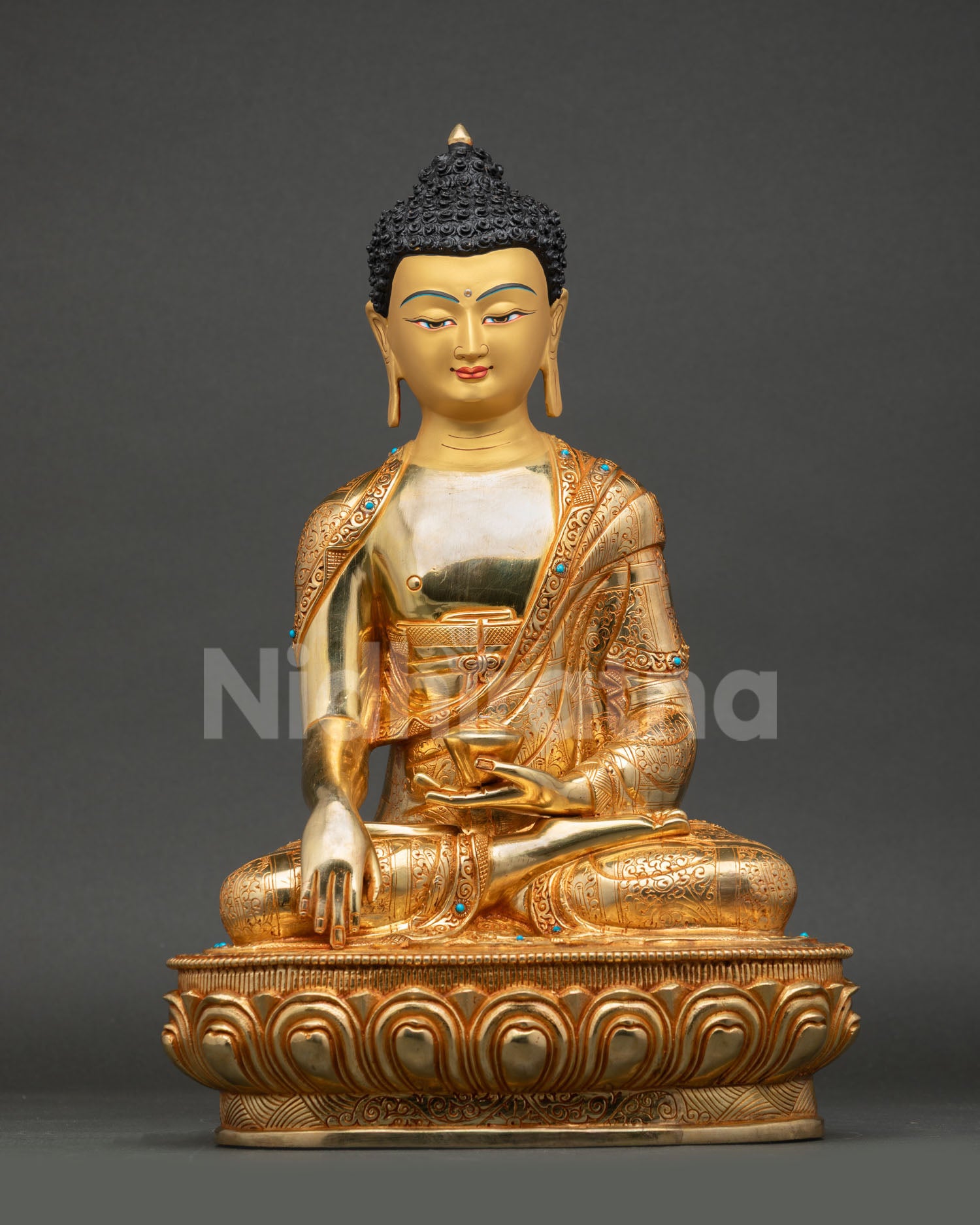 Front view of Shakyamuni Buddha statue handcrafted by Newari artisan from Patan, Nepal copper gold detailing gold painted face