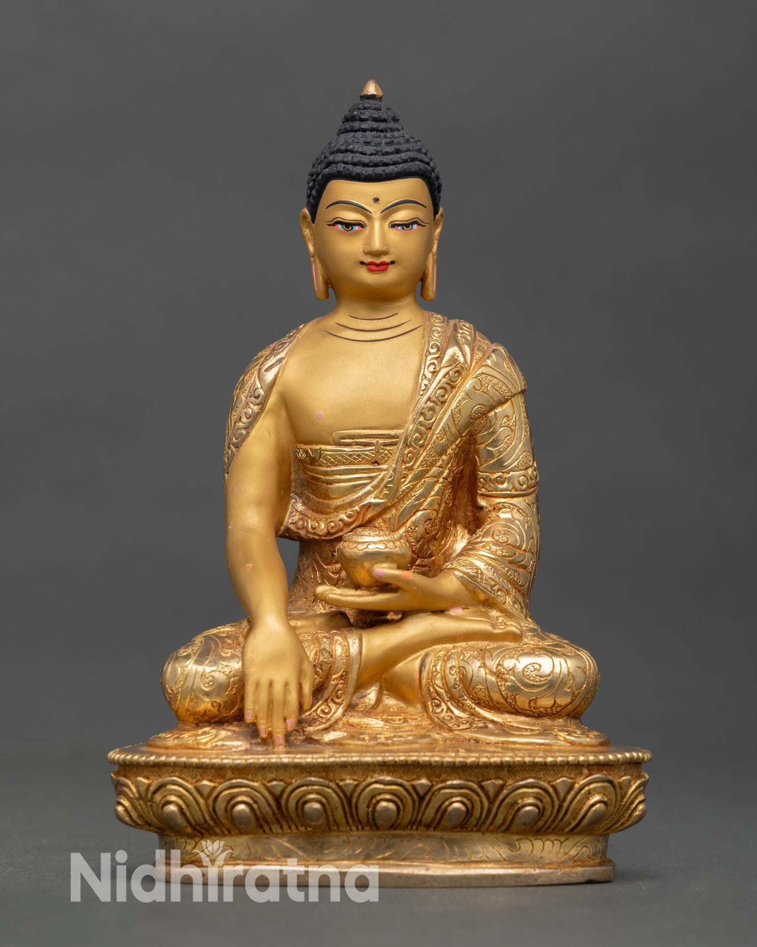 Front view of Shakyamuni Buddha statue handcrafted in copper with gold gilded finish seated on lotus pedestal showing earth touching mudra