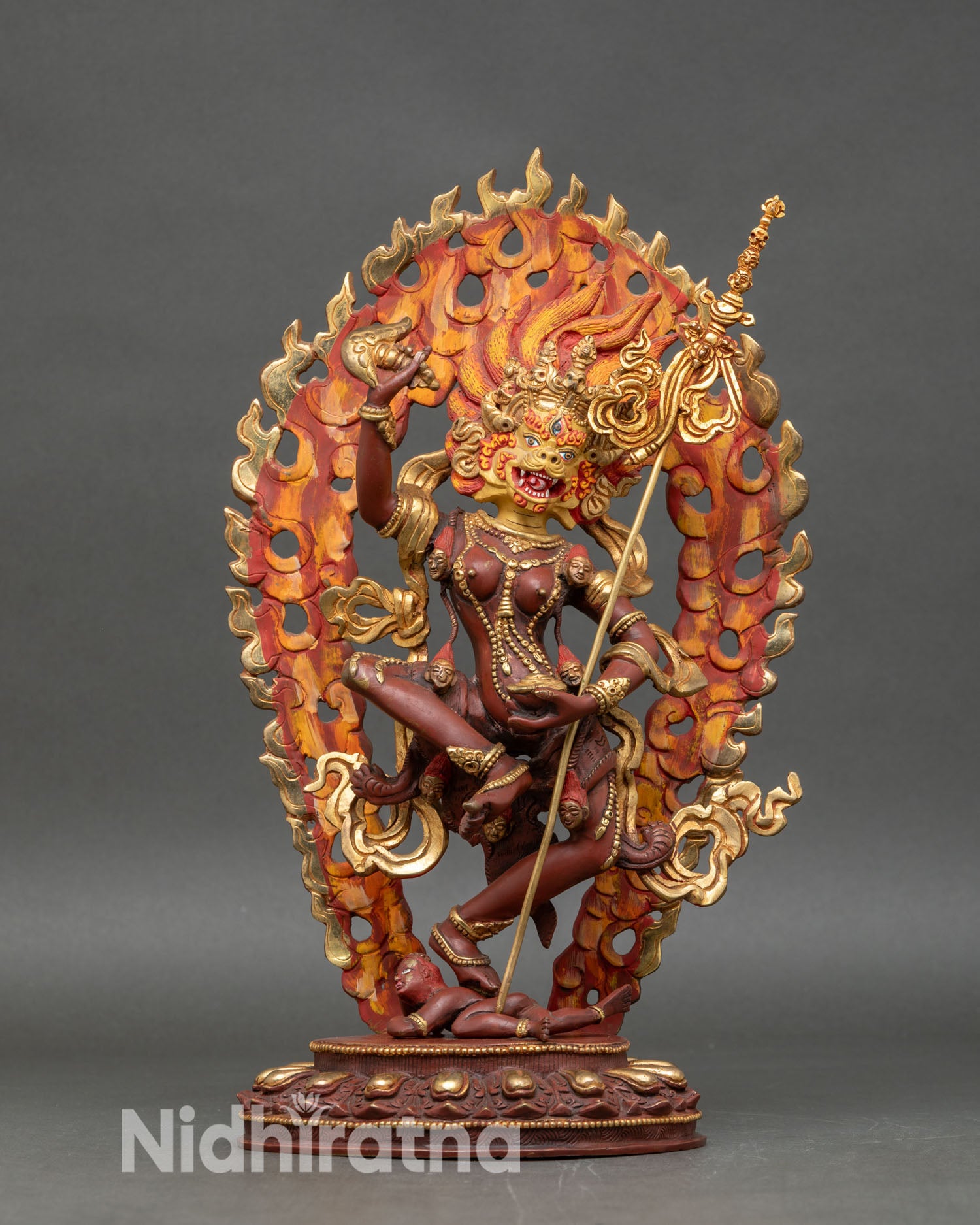 Front view of Simha Mukha statue, lion-faced Dakini, oxidized copper, gold Nepalese sculpture