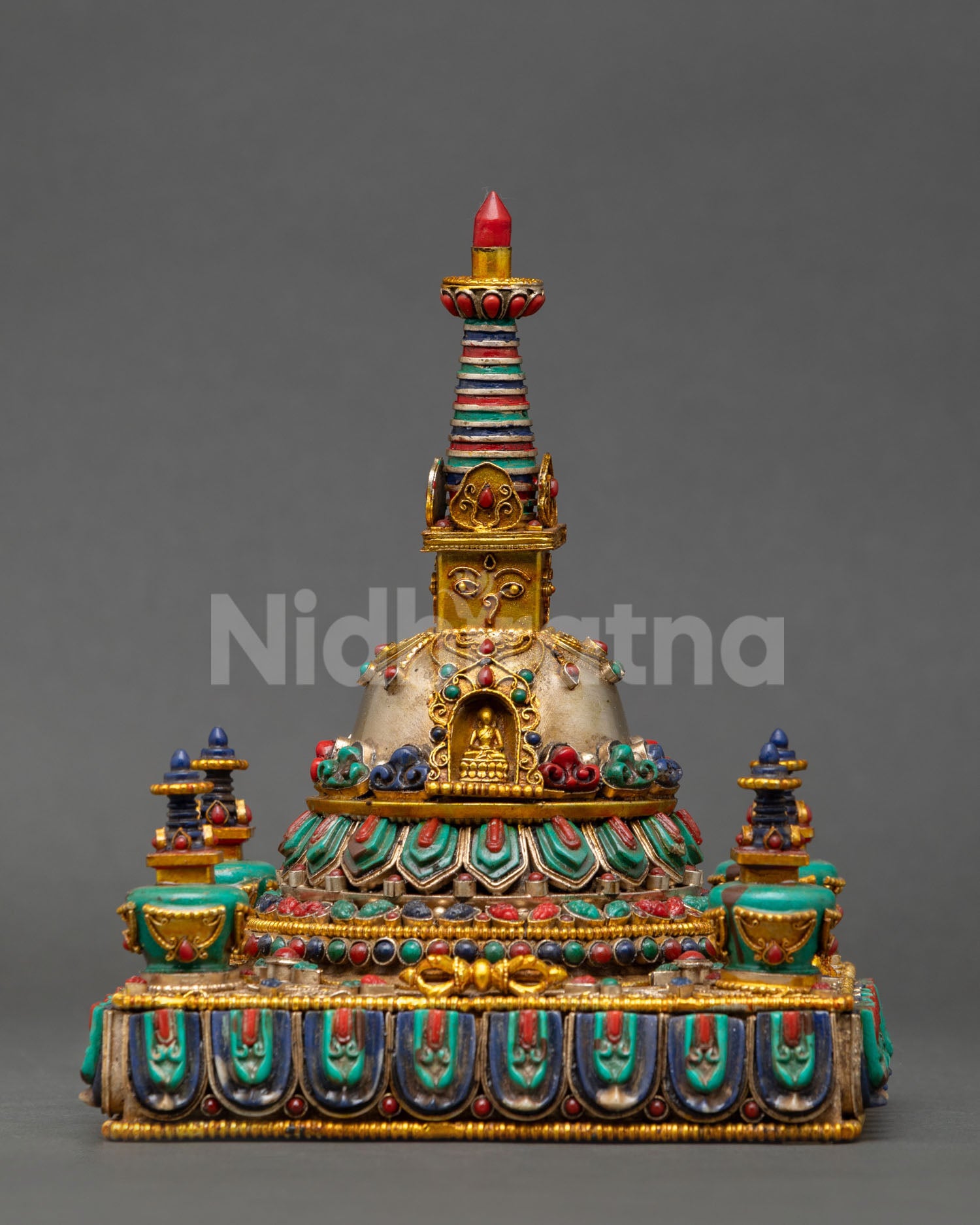 Front view of Tibetan Buddhist Stupa handcrafted by Newari artisans with 24K gold and silver plating, sacred Himalayan altar sculpture with Buddha eyes and jewel finial