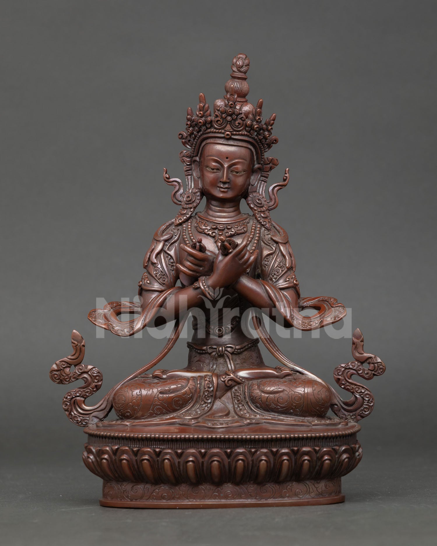Front view of Vajradhara statue handcrafted in oxidized copper with crossed arm posture vajra and bell for Buddhist altar and meditation decor.