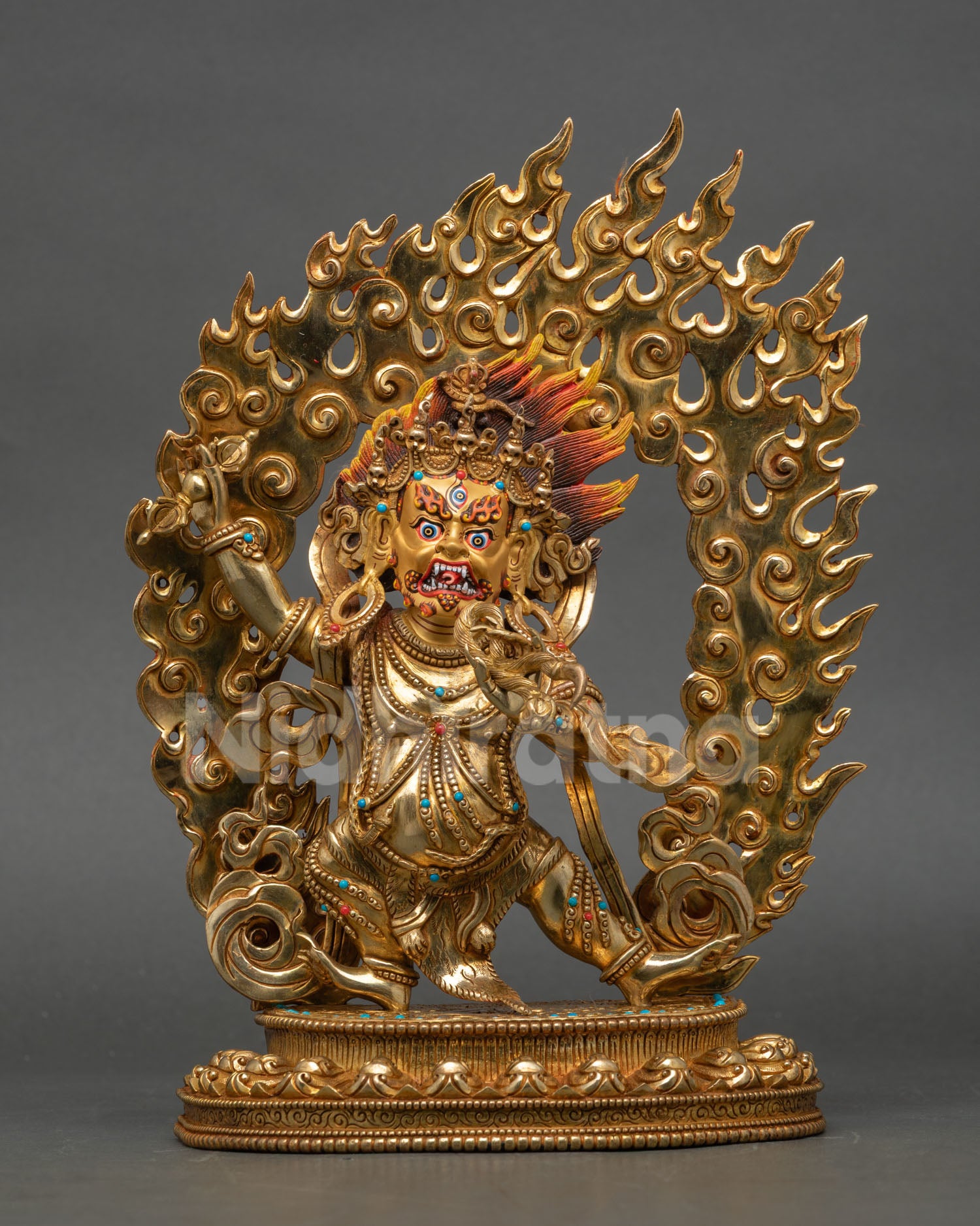 Front view of Vajrapani statue handmade in copper with gold gilding semi precious stones flaming halo and lotus pedestal