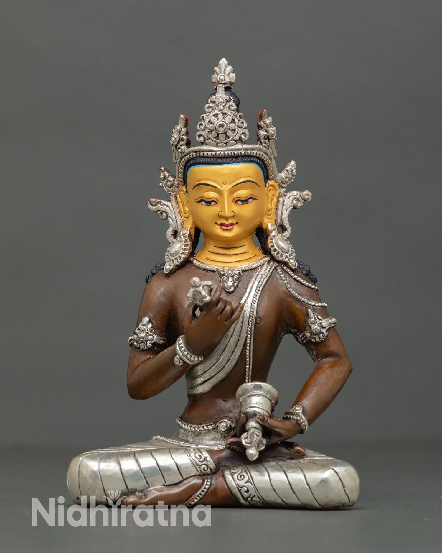 Front view of Vajrasattva statue oxidized copper silver plated details 24K gold face handmade Nepal Buddhist altar sculpture