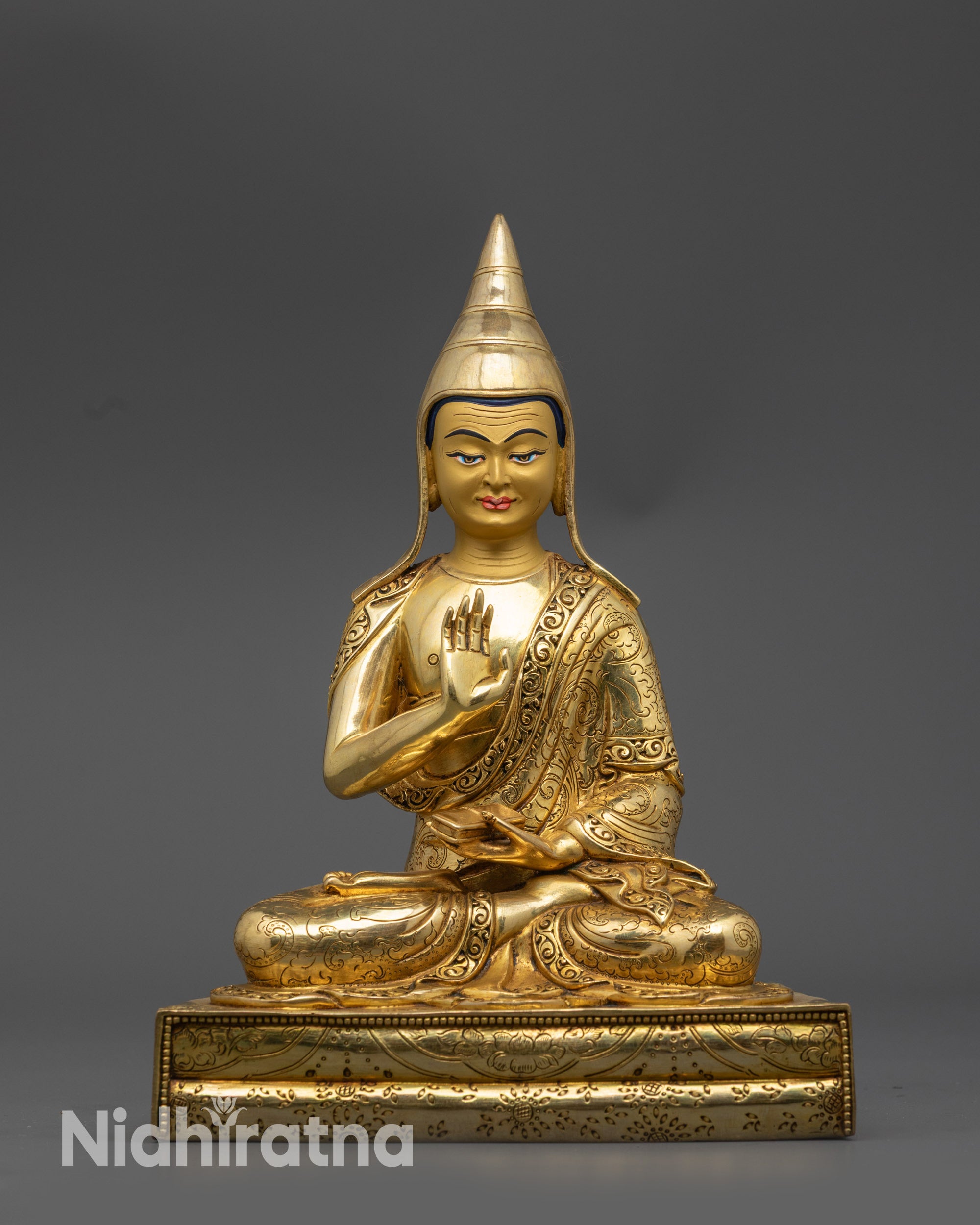 front view Santaraksita statue with gold-gilded face and yellow lama hat