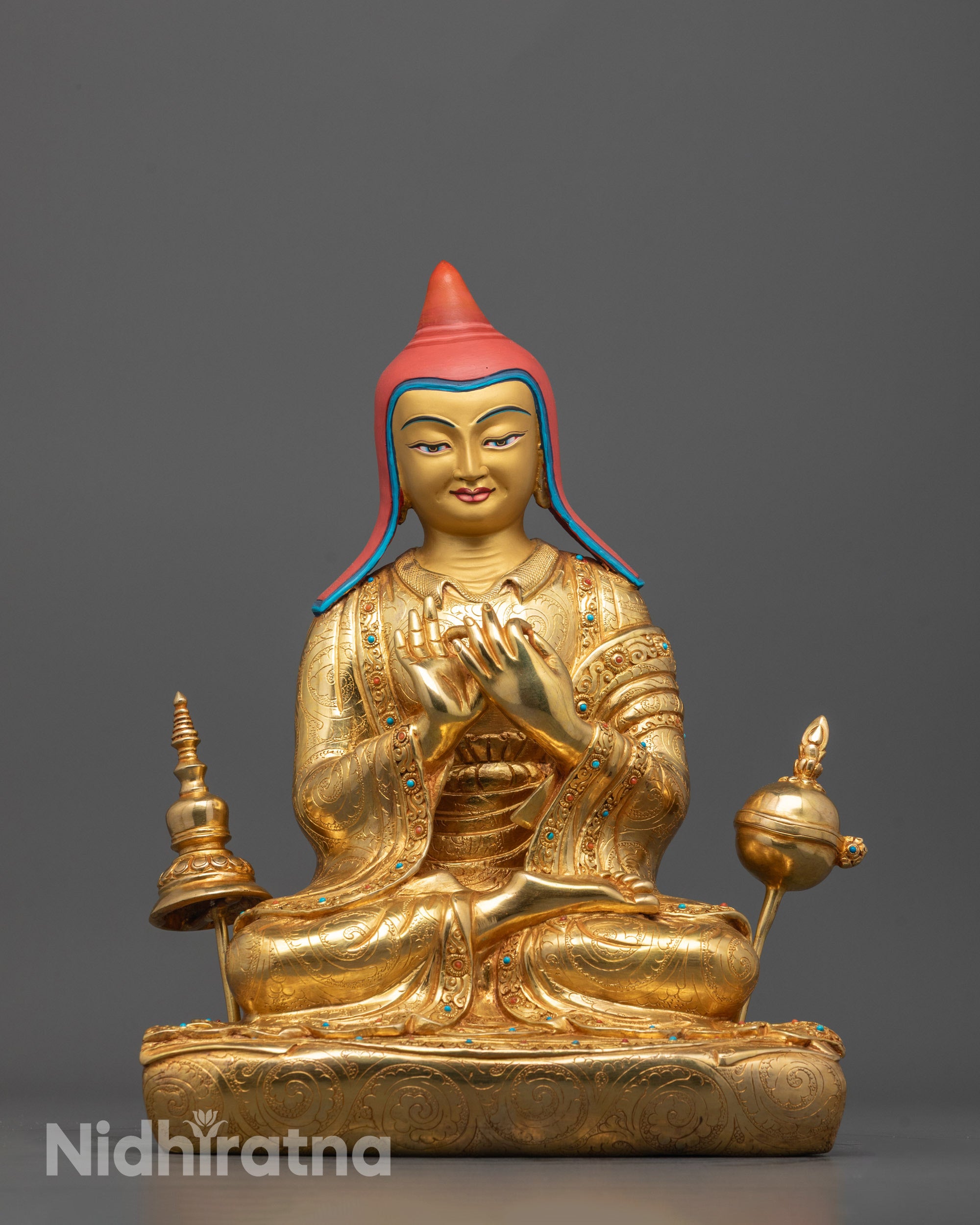 front view of Atisa statue with gold-gilded face and fire-gilded body in dharmachakra mudra