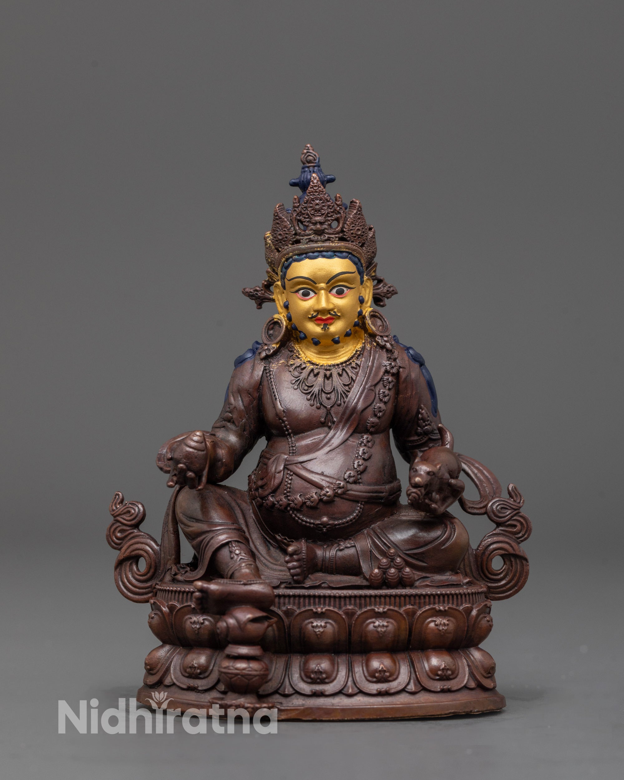 front view of Dzambhala statue with oxidized copper body and 24K gold-plated face