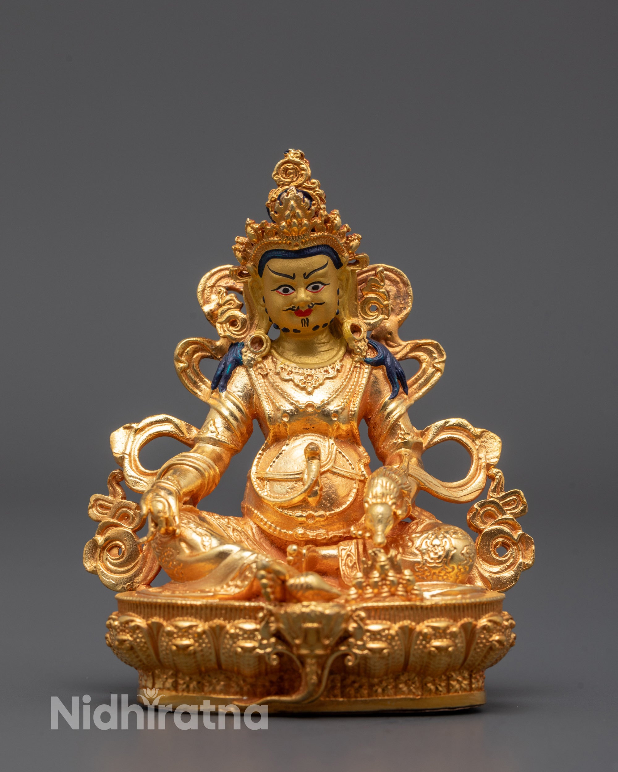 front view of Jambhala statue with gold-gilded face and mongoose in hand