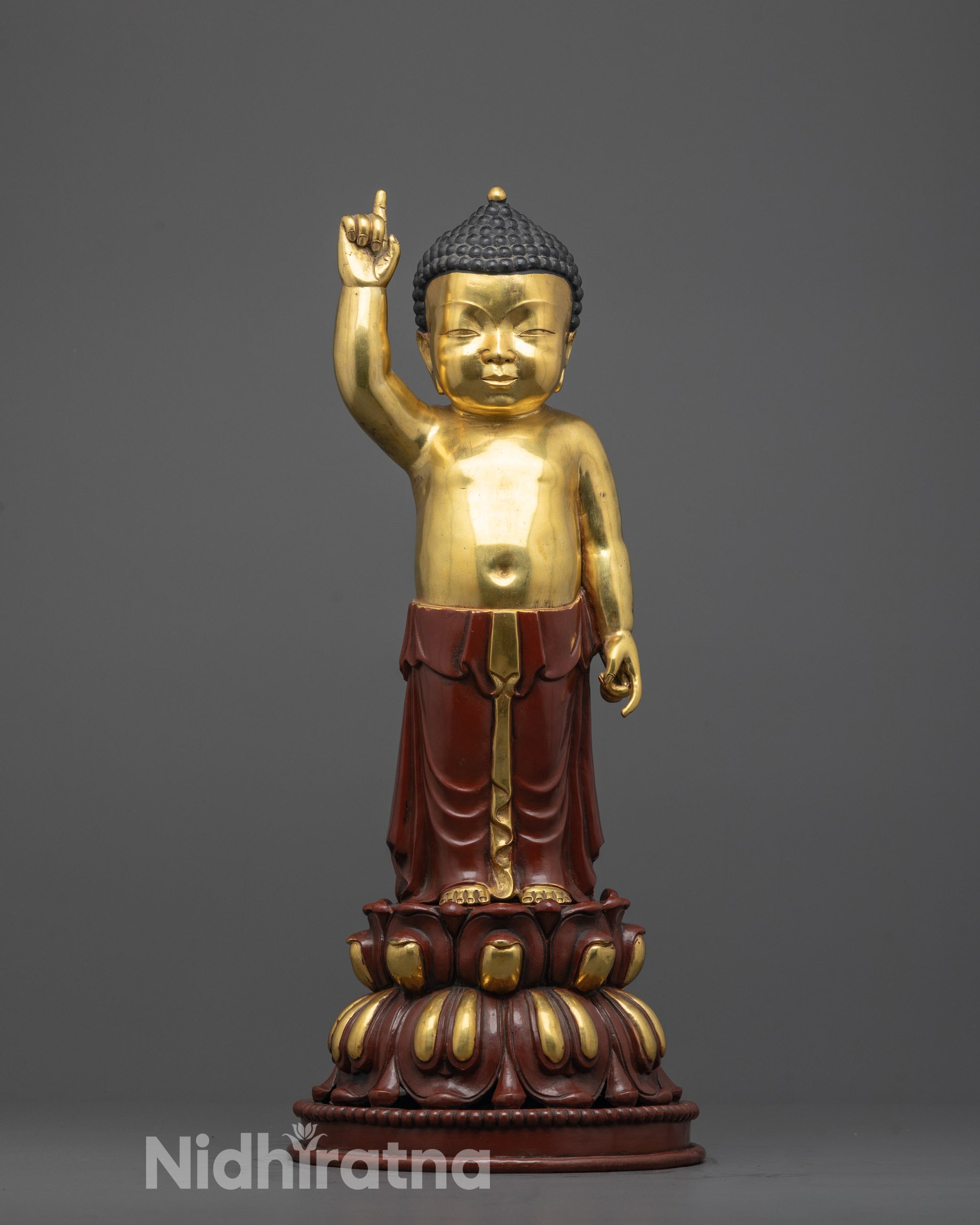 front view of handcrafted little buddha statue with gold gilded face on lotus seat