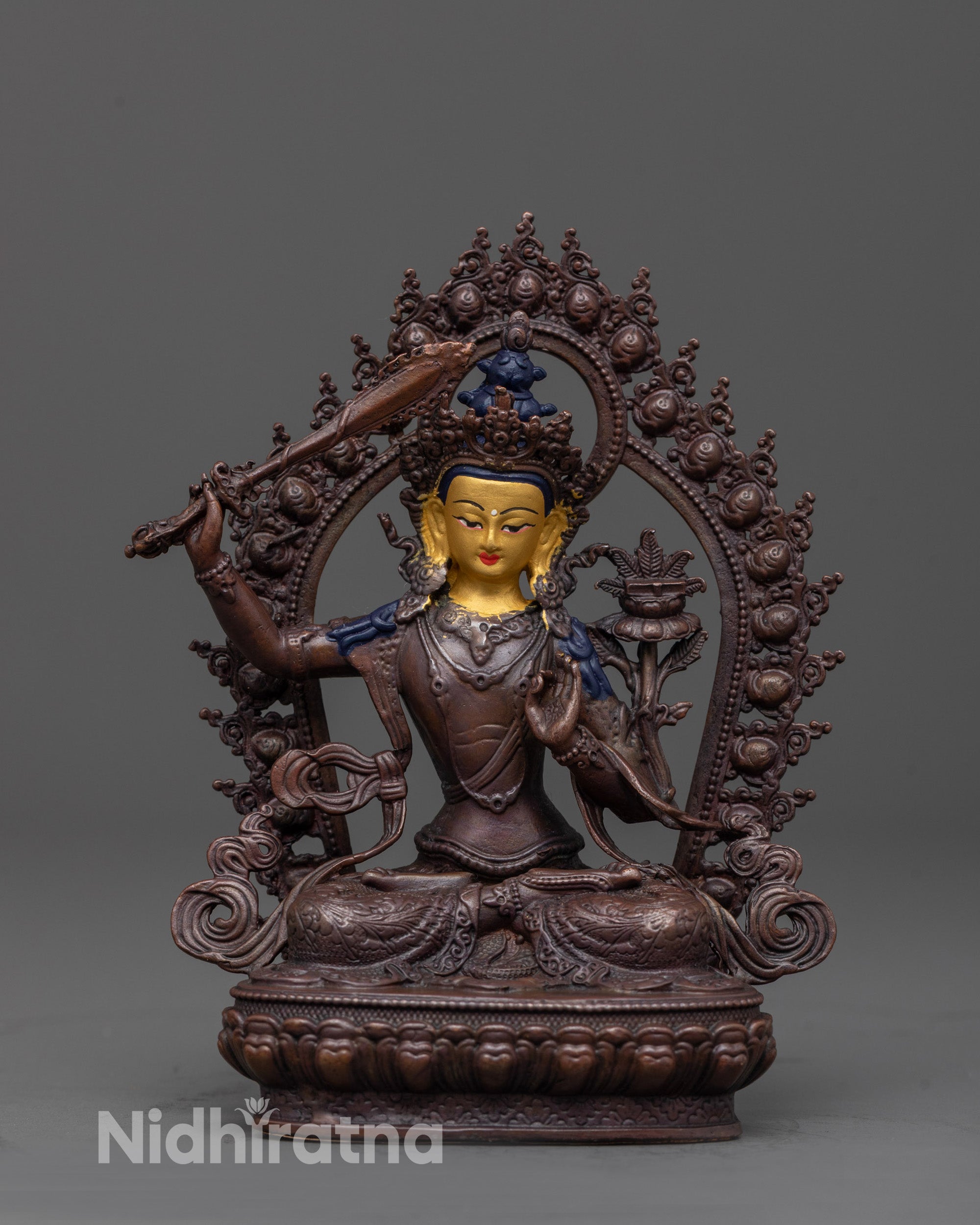 front view of manjushri statue with gold-plated face and oxidized copper body for wisdom decor