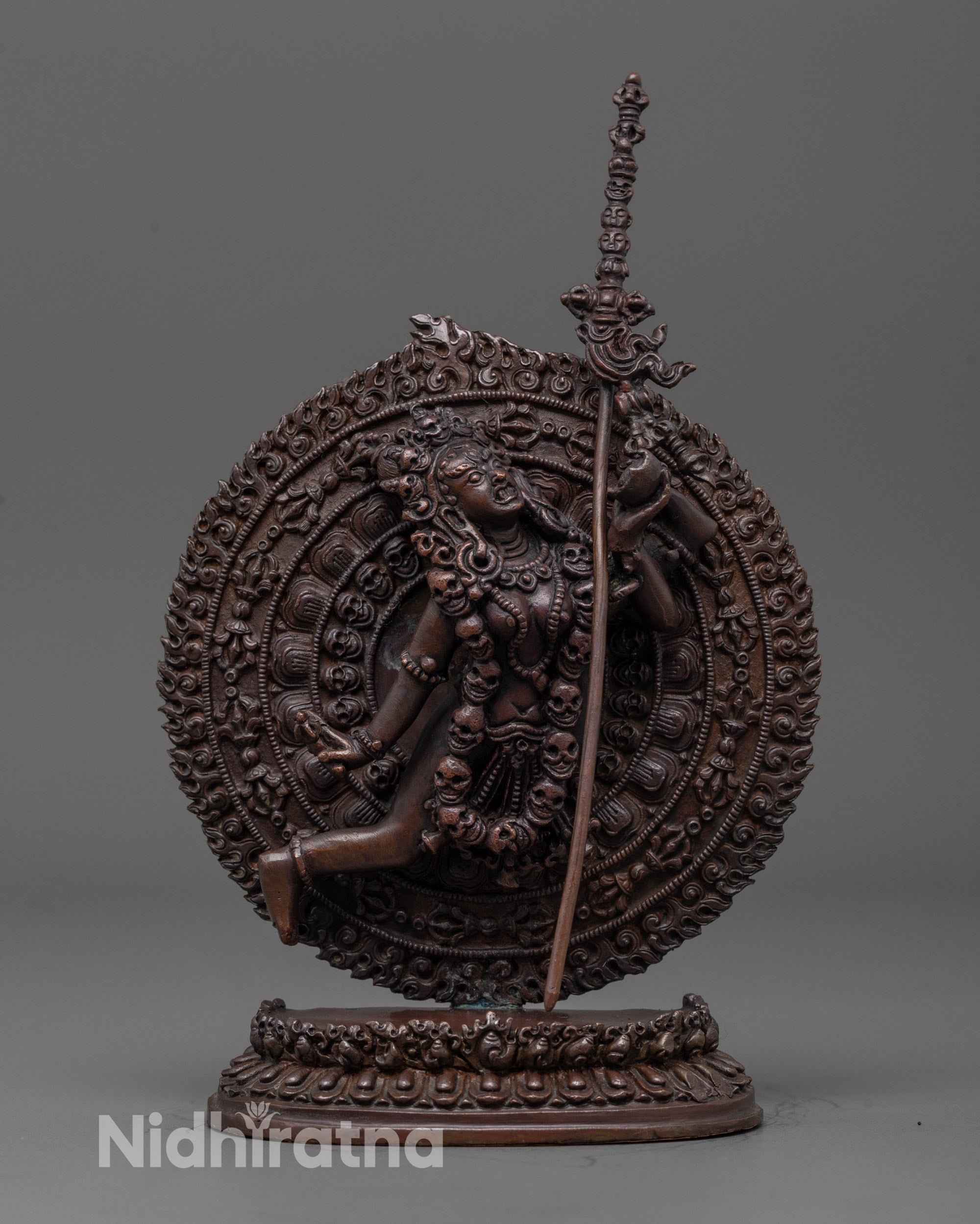 front view of oxidized Flying Vajrayogini statue with fire halo and skull crown detail