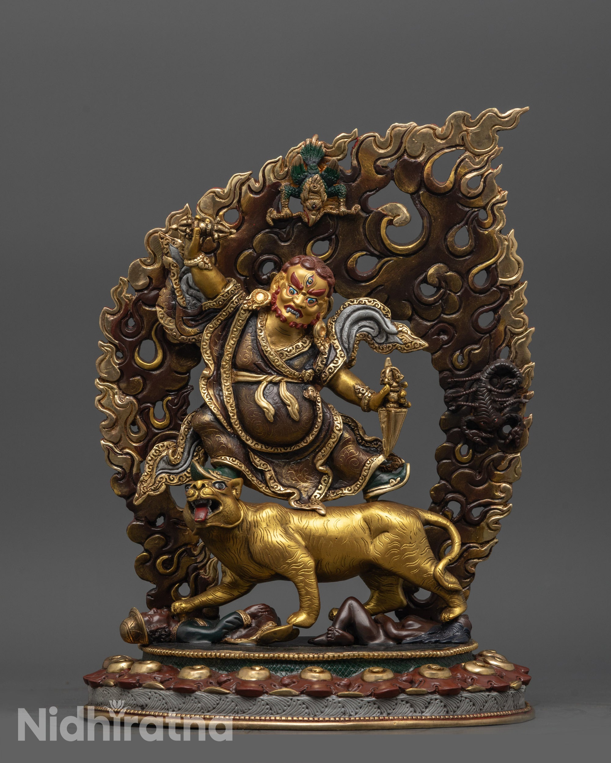front view of oxidized dorje drolo statue with gold-plated details and halo