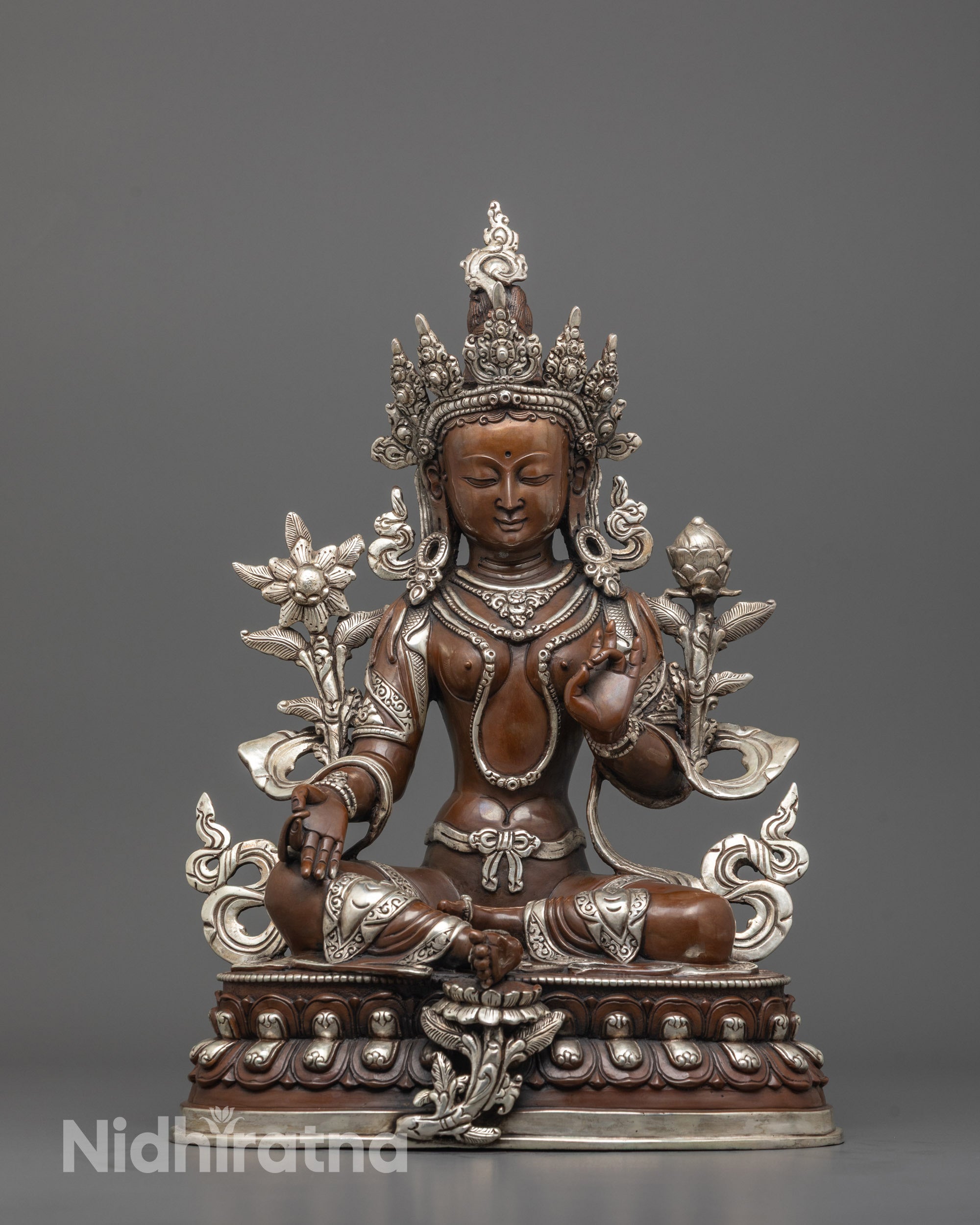 front view of oxidized green tara statue with silver-plated crown and lotus seat for meditation spaces