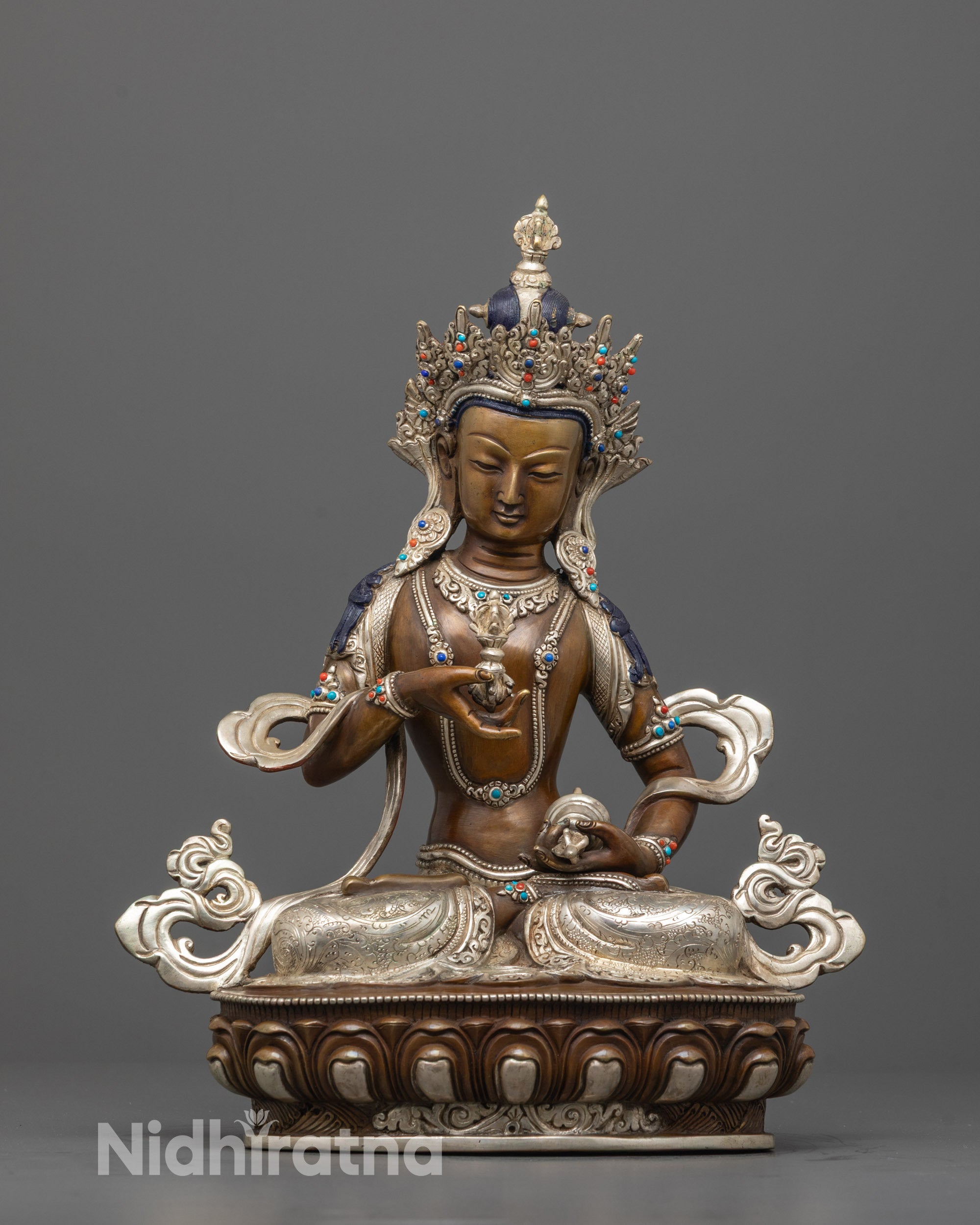 front view of oxidized vajrasattva statue with silver-plated crown and serene expression
