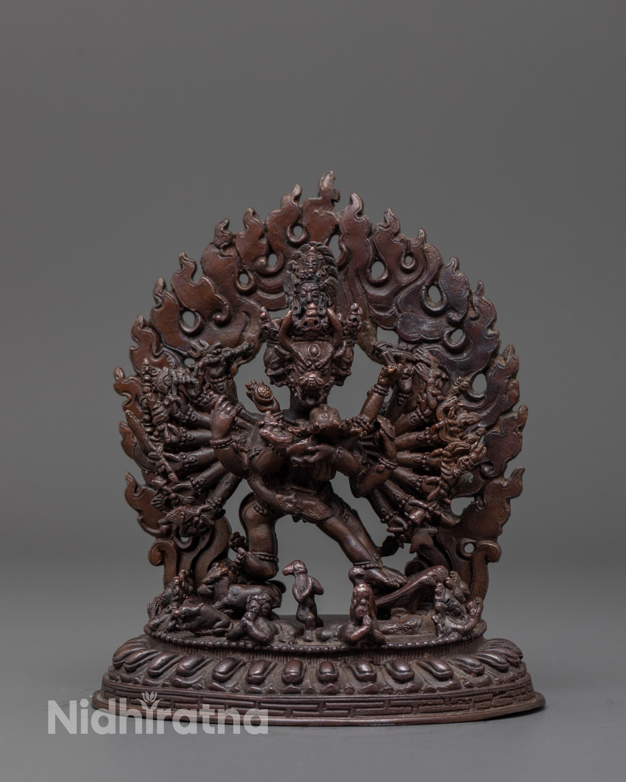 front view of oxidized yamantaka statue with multiple arms and fierce deity stance