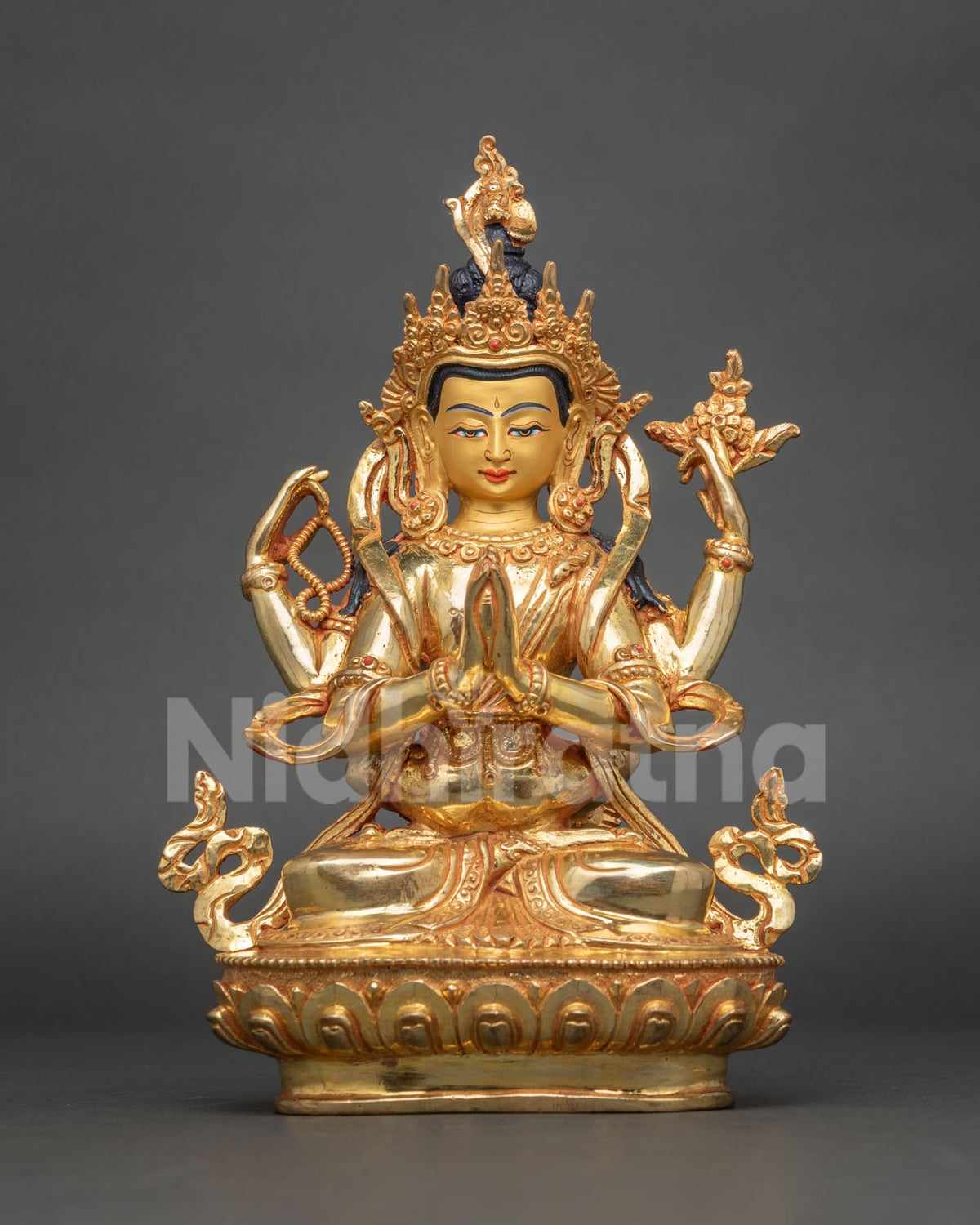 Full-length view of gilded Four-Armed Chenrezig Yab-Yum statue on carved lotus pedestal