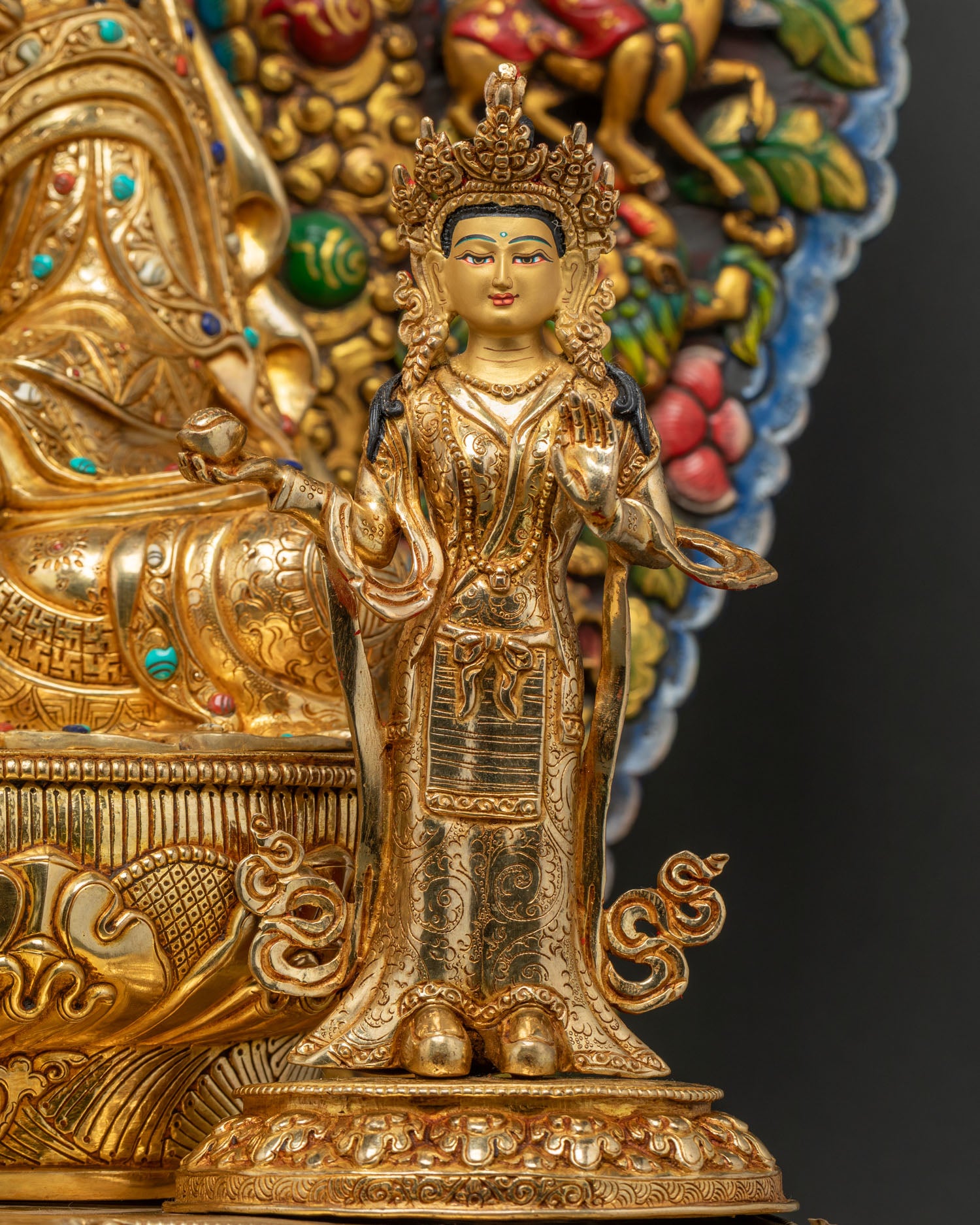 full-length view of standing consort figure beside Guru Rinpoche statue