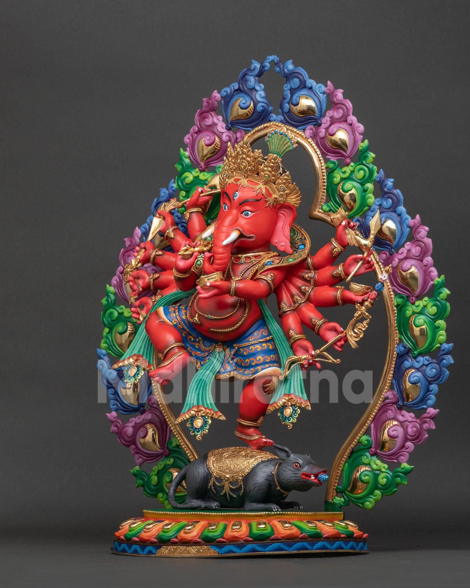 Ganesh statue left view showing flowing robes lotus seat and carved floral halo.