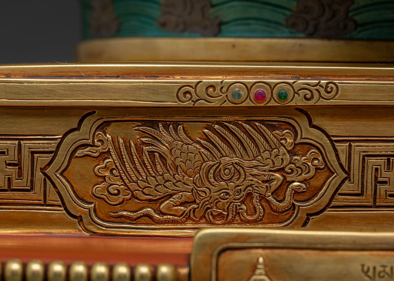 Garuda relief carving detail on Dzambhala Statue's ornate throne