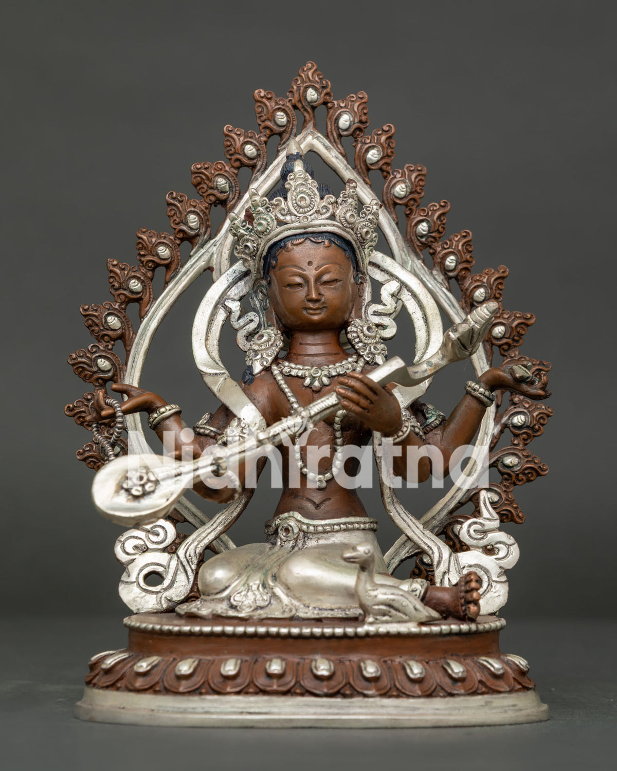 Goddess Saraswati Statue front view seated on lotus pedestal with floral halo