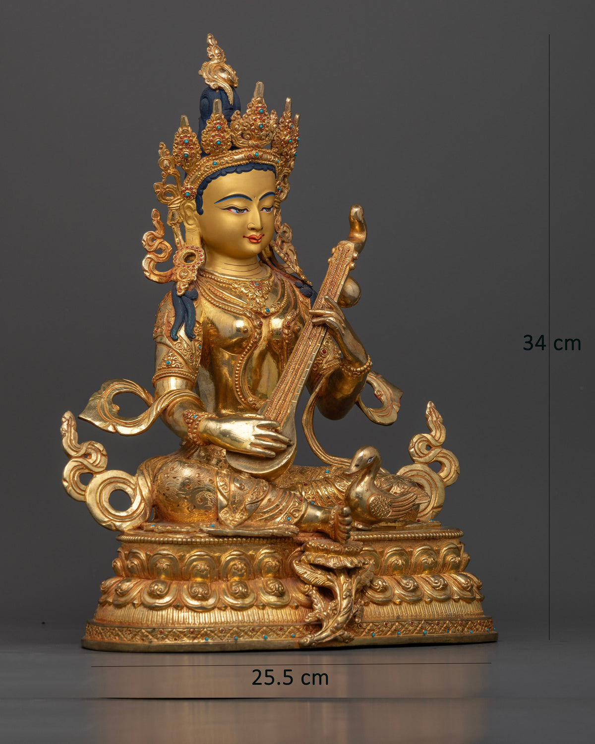 Goddess Saraswati Statue seated on lotus pedestal with swan.