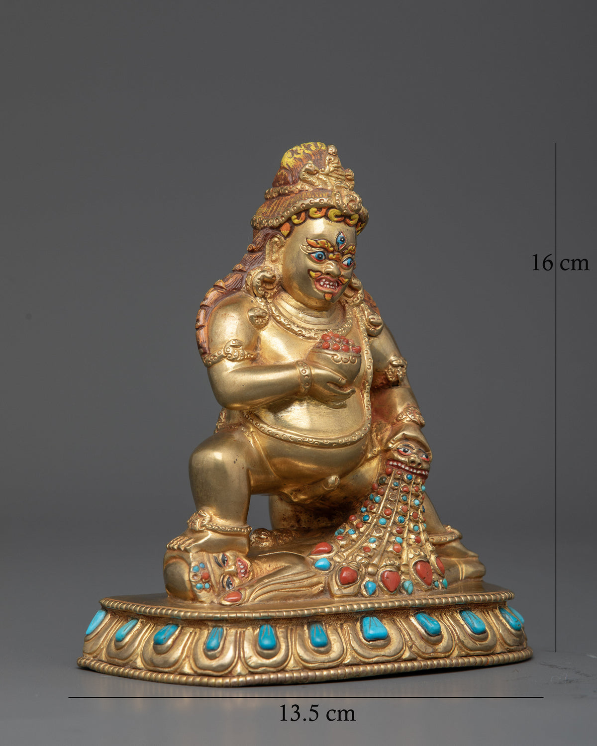 Gold fire gilded Black Dzambhala statue with semi precious stones.