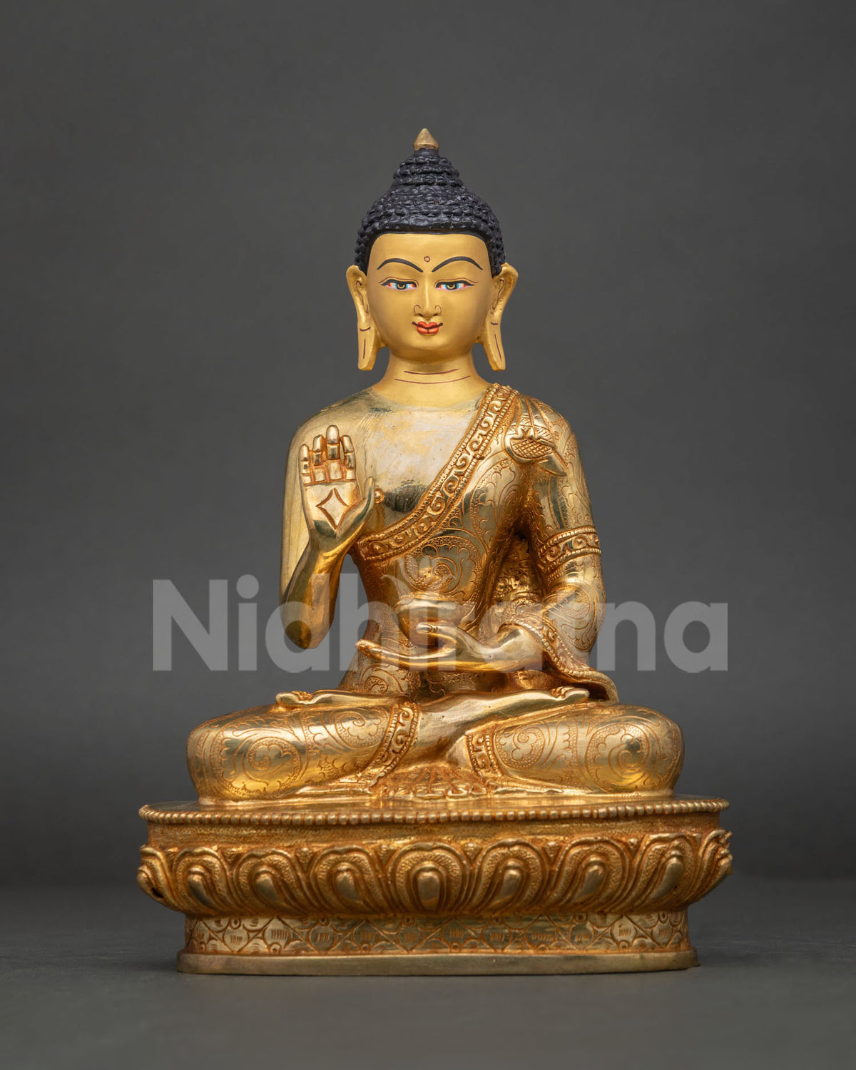 Gold fire-gilded copper Buddha statue with right hand raised in Abhaya mudra, Nepalese Buddhist art