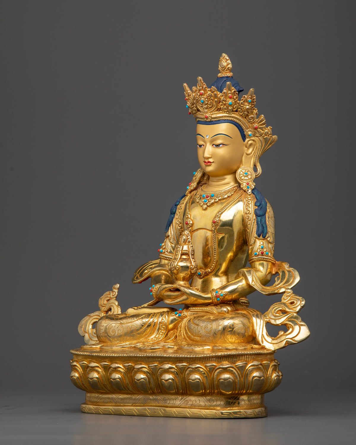 Gold-gilded Amitayus Buddha sculpture featuring semi-precious stones and traditional lost-wax casting craftsmanship