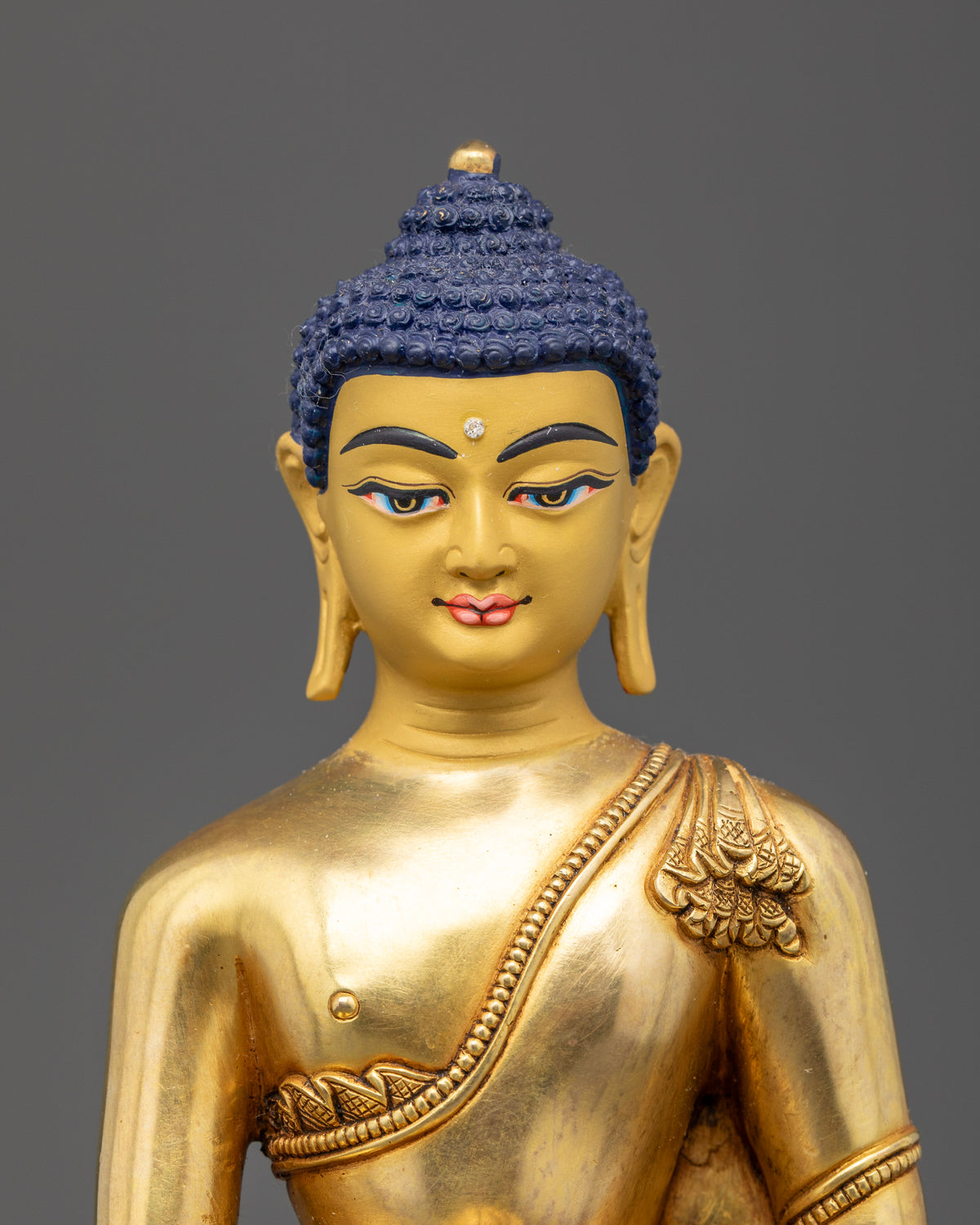 Gold-gilded Shakyamuni Buddha statue with finely sculpted facial features and traditional Newari craftsmanship