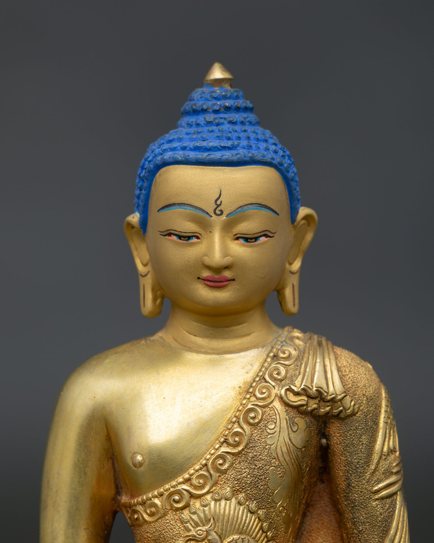 Gold painted Amitabha Buddha sculpture with engraved monastic robe featuring traditional Buddhist mythical birds