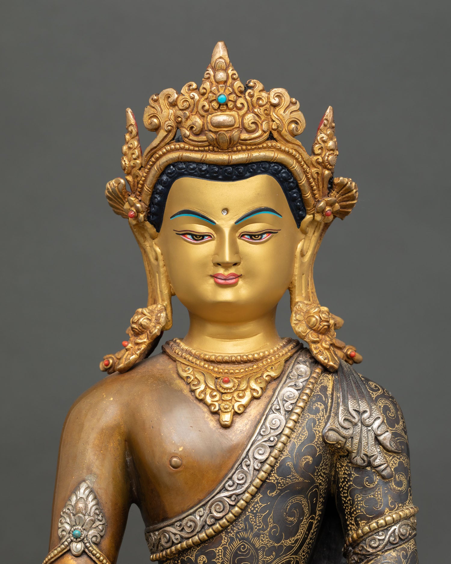 Gold-painted face of Gautama Buddha Statue with traditional Nepalese craftsmanship