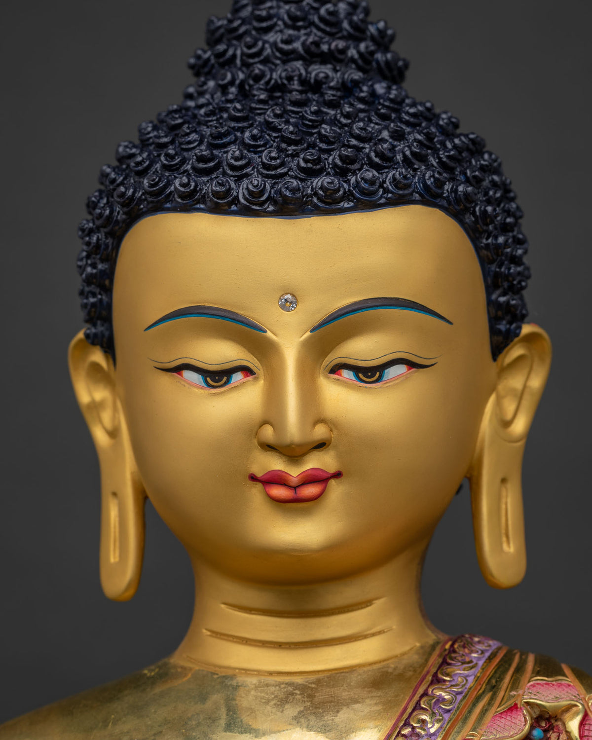 Gold-painted serene face of handcrafted Shakyamuni Buddha statue from Nepal