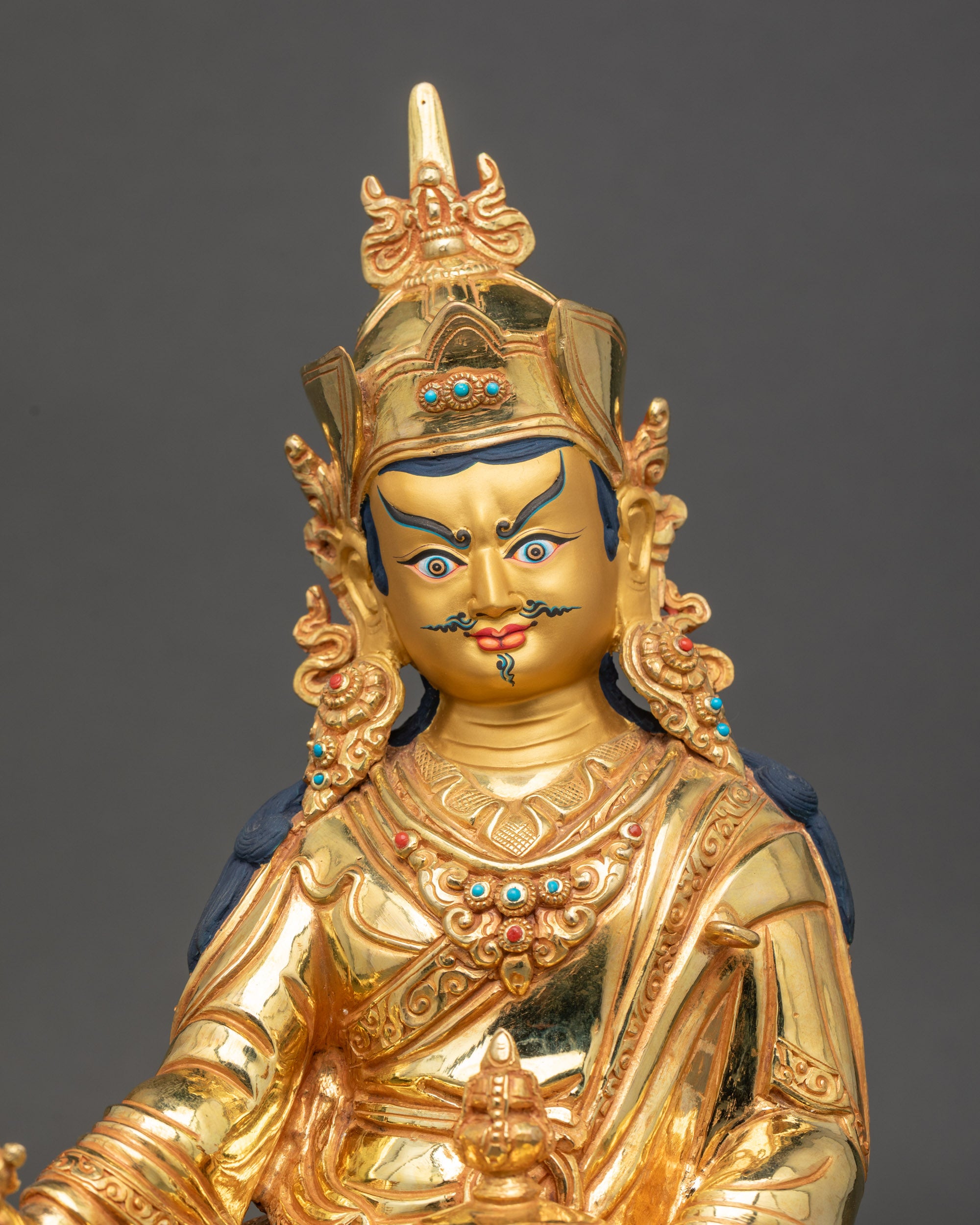 gold-painted face of Guru Rinpoche, wrathful compassion, handcrafted Nepalese sculpture