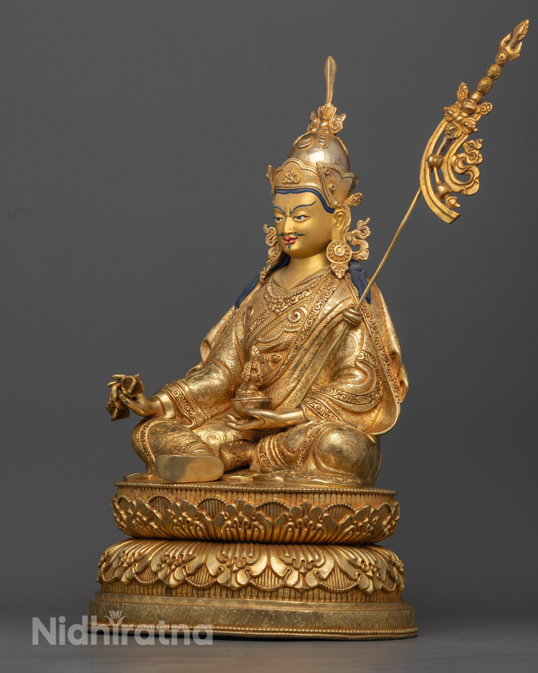 gold-plated Guru Rinpoche Statue showcasing Vajra and Khatvanga with spiritual symbolism