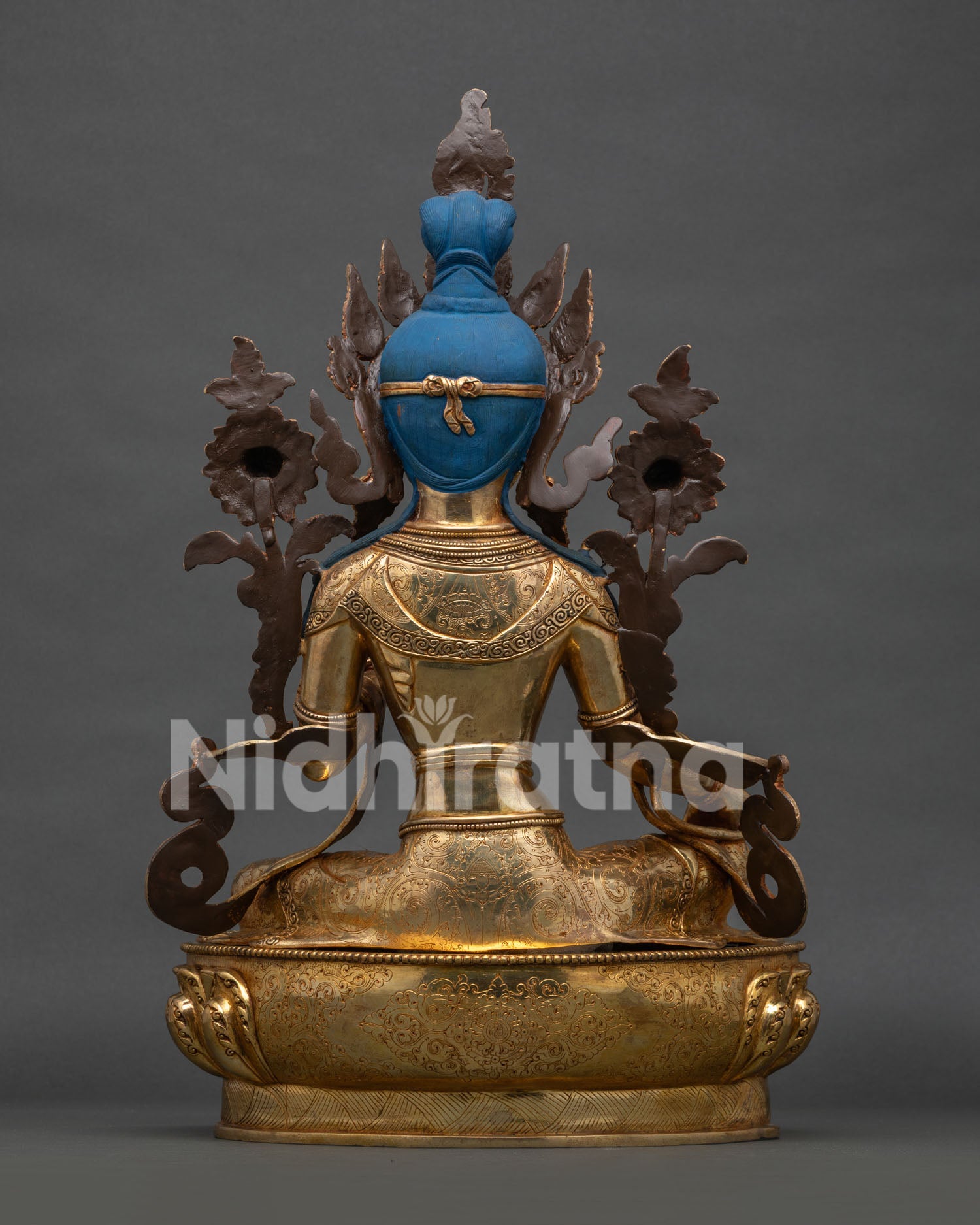 Green Tara back view, intricate hand-carved detailing on robes and double-tiered lotus pedestal base