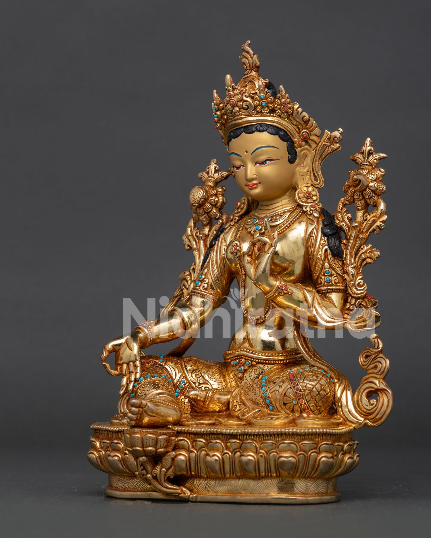 Green Tara Bodhisattva statue with intricate ornate jewelry.