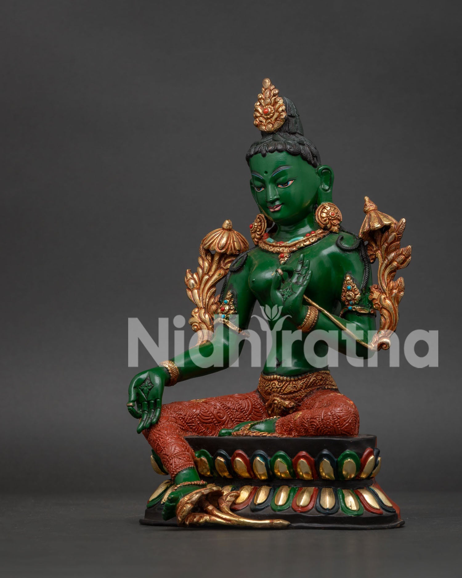 Green Tara Buddhist statue left side showing green body gold gilding and lotus