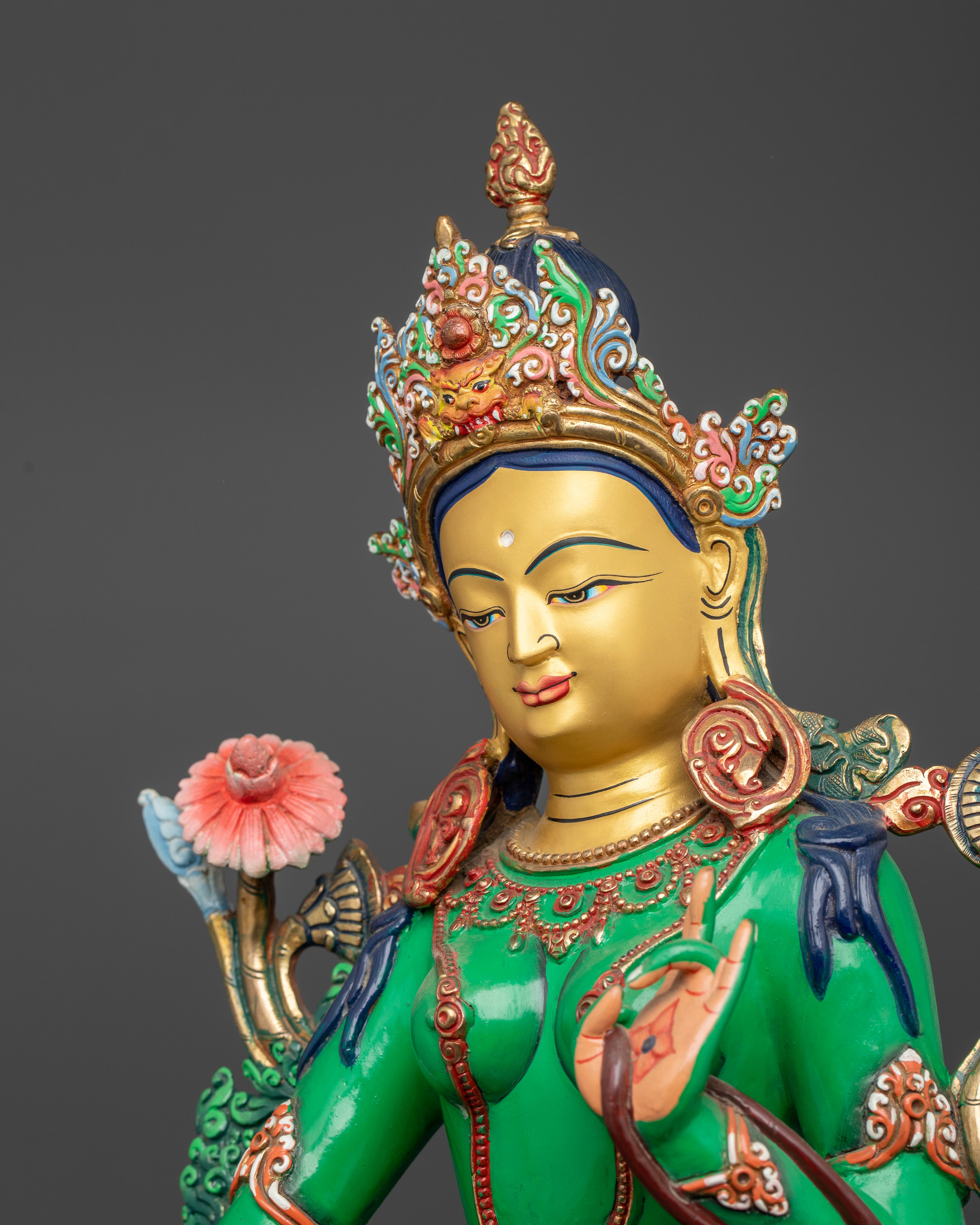 Green Tara Buddhist statue with hand painted floral crown and ornate jewelry.