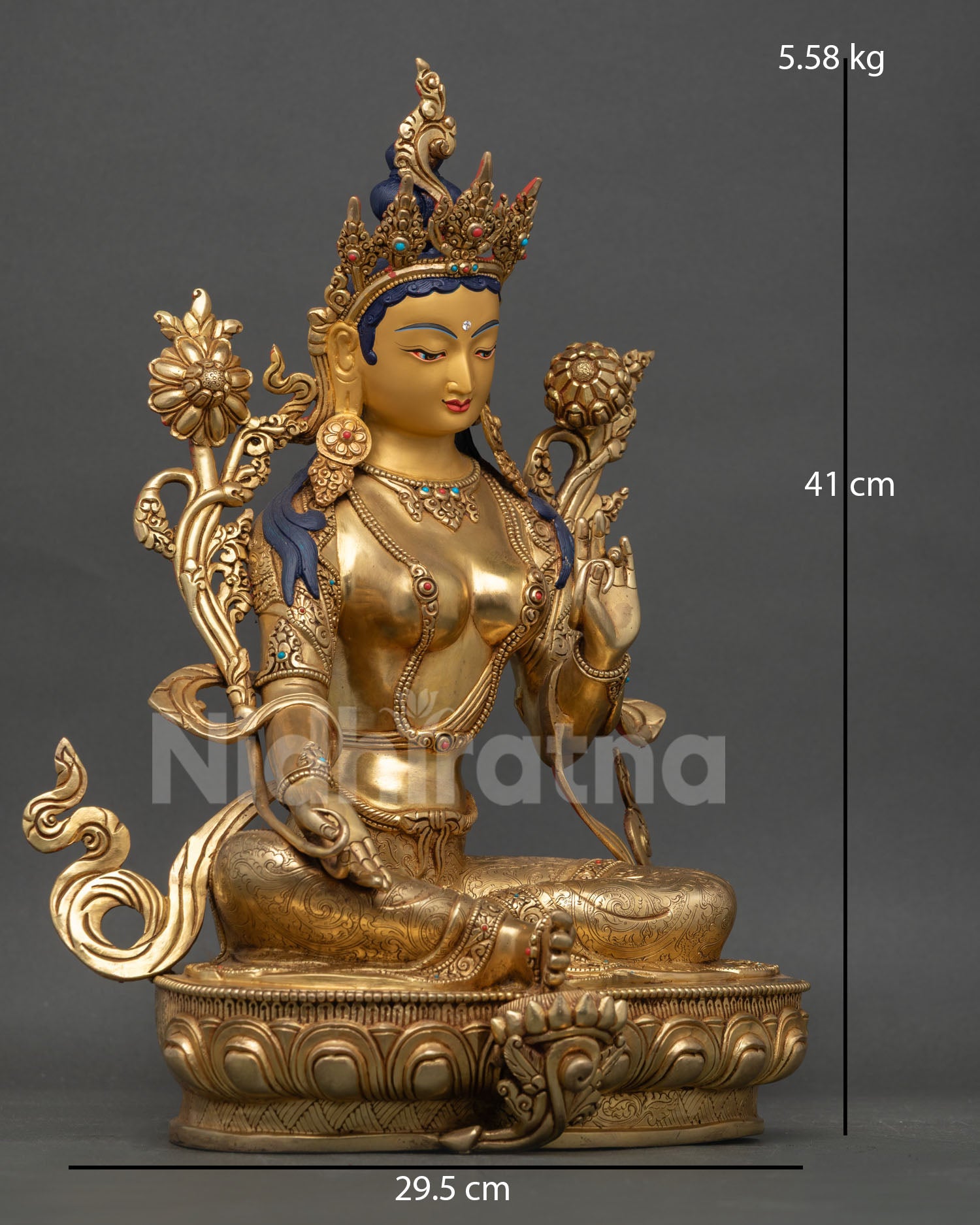 Green Tara goddess sculpture with extended right leg and detailed sacred ornaments