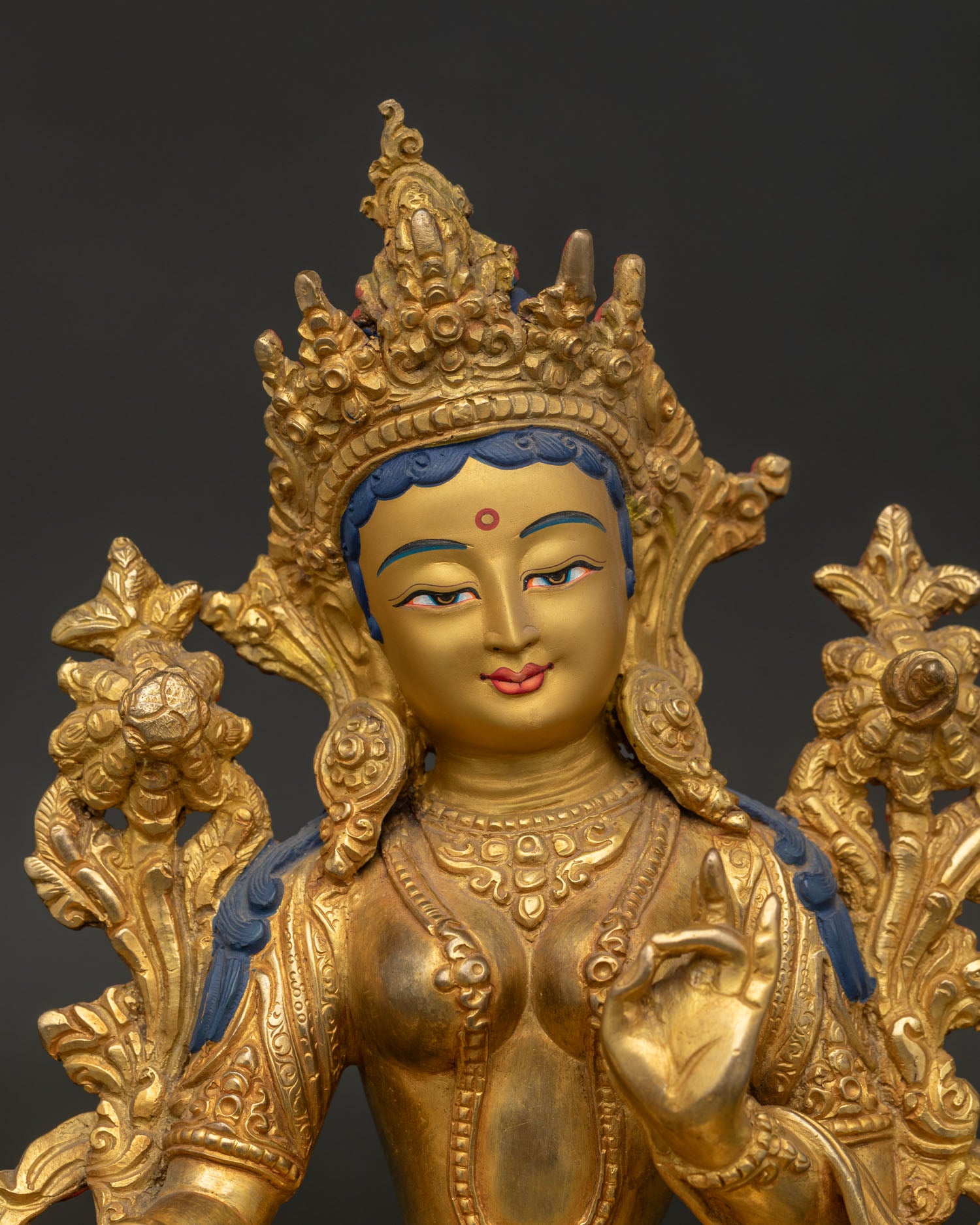Green Tara Gold Painted Face with Serene Expression Close Up View.
