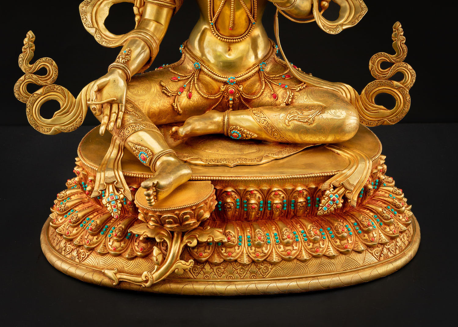 Green Tara lotus base carved with intricate patterns showing fine Nepalese metal artistry and spiritual symbolism