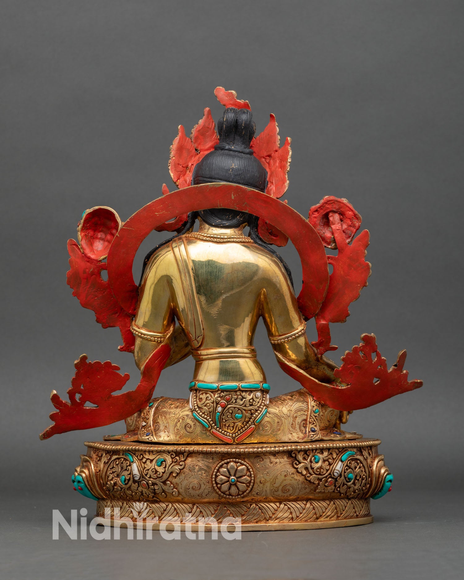 Back view of Green Tara statue with detailed hair, crown, and lotus throne
