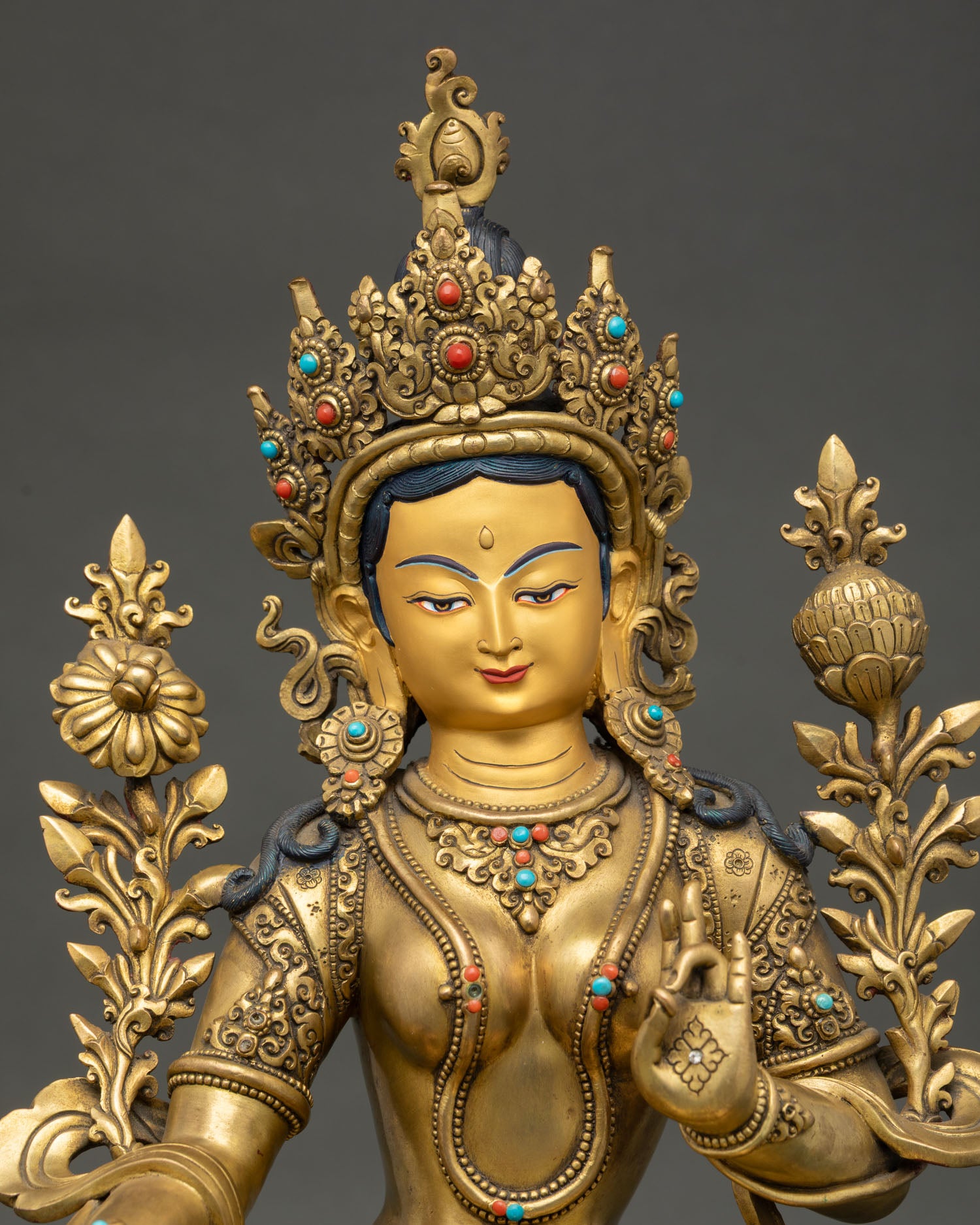 green tara statue close up showing intricate crown jewelry and nepalese craftsmanship